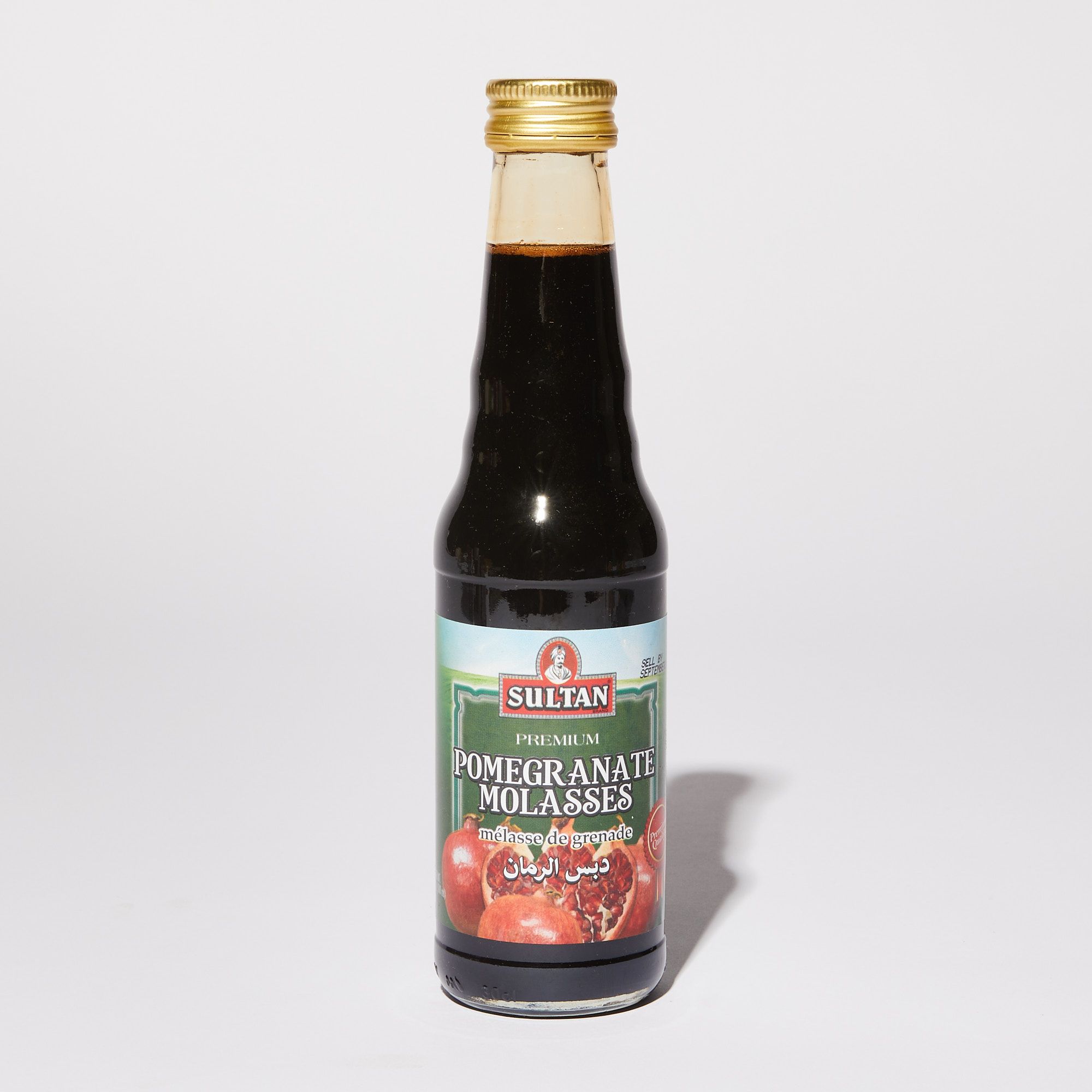 Clear bottle with dark syrup featured a label with a photo of pomegranates