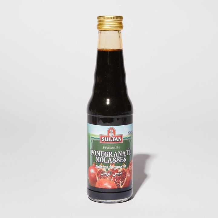 Clear bottle with dark syrup featured a label with a photo of pomegranates