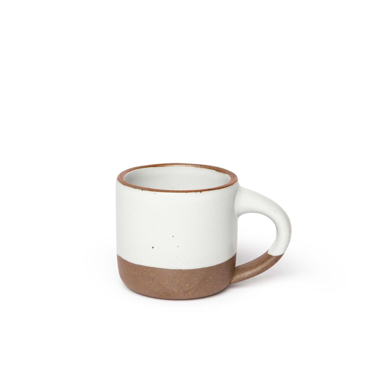 A small sized ceramic mug with handle in a cool white glaze featuring iron speckles and unglazed rim and bottom base.