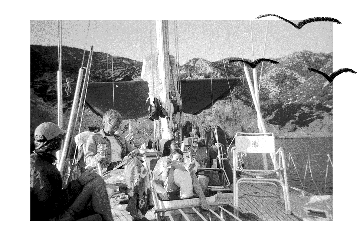 Group of friends sitting on a sailboat