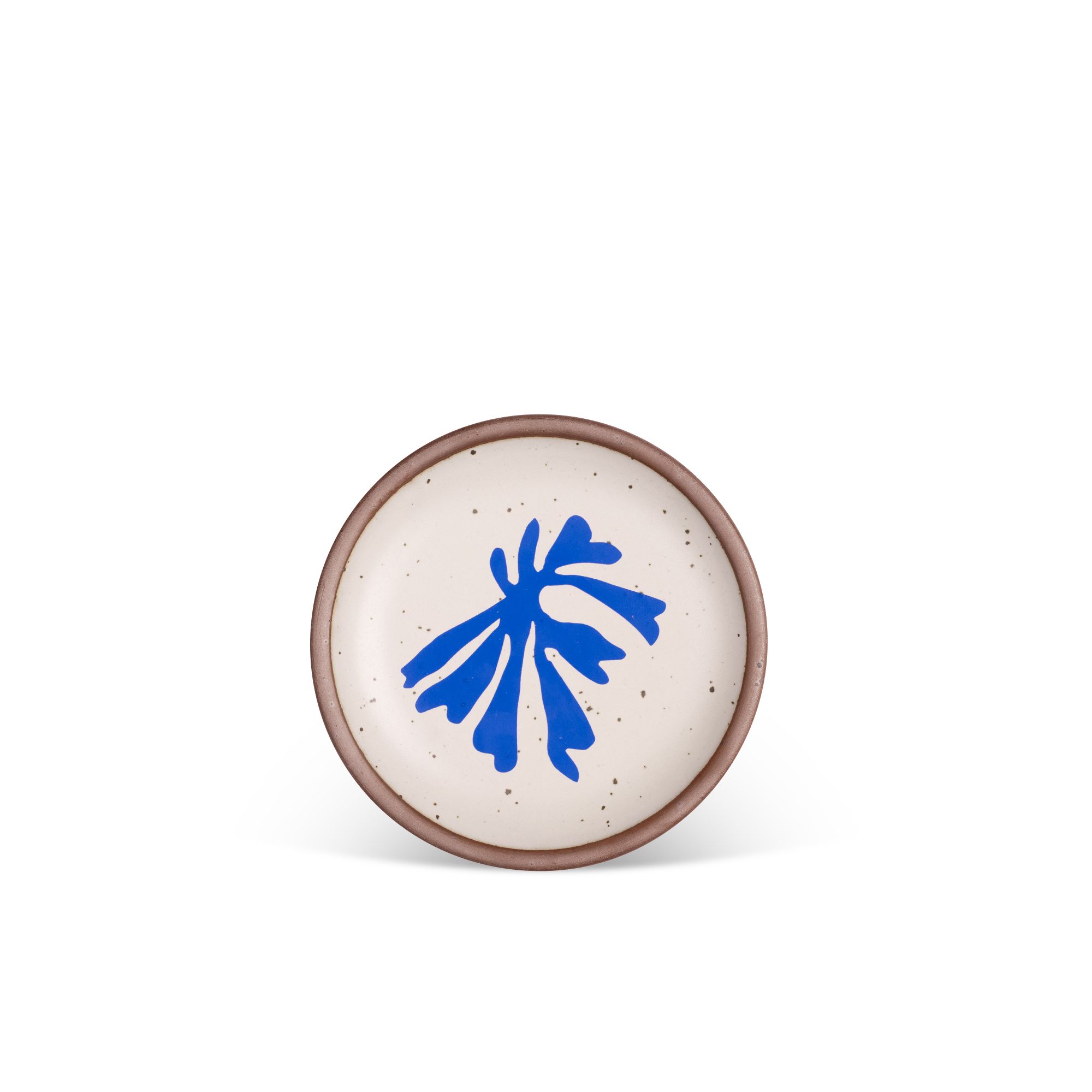 Abstract shape of a leaf in bright blue, centered on an off-white ceramic plate with an unglazed rim.