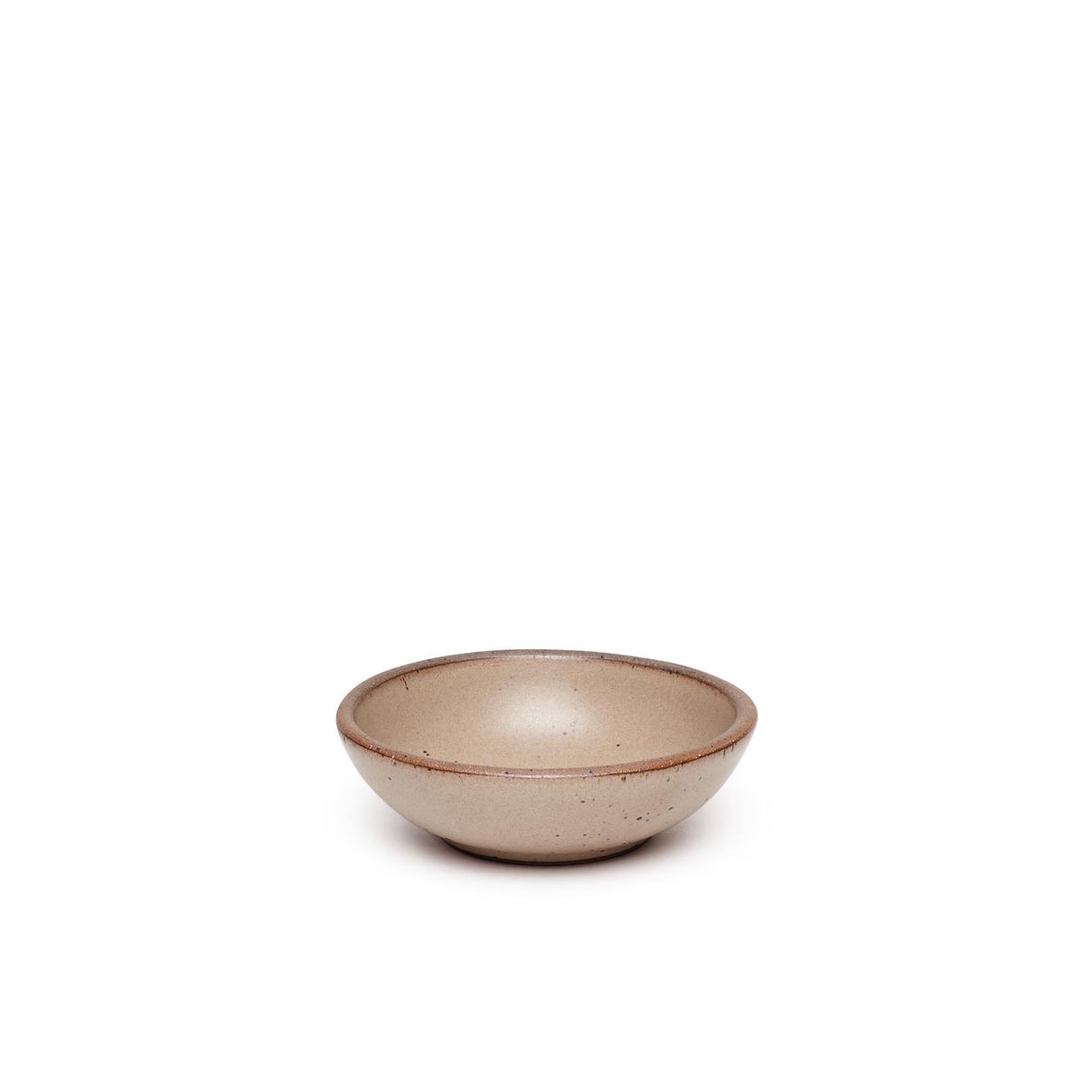 A small shallow ceramic bowl in a warm pale brown color featuring iron speckles and an unglazed rim