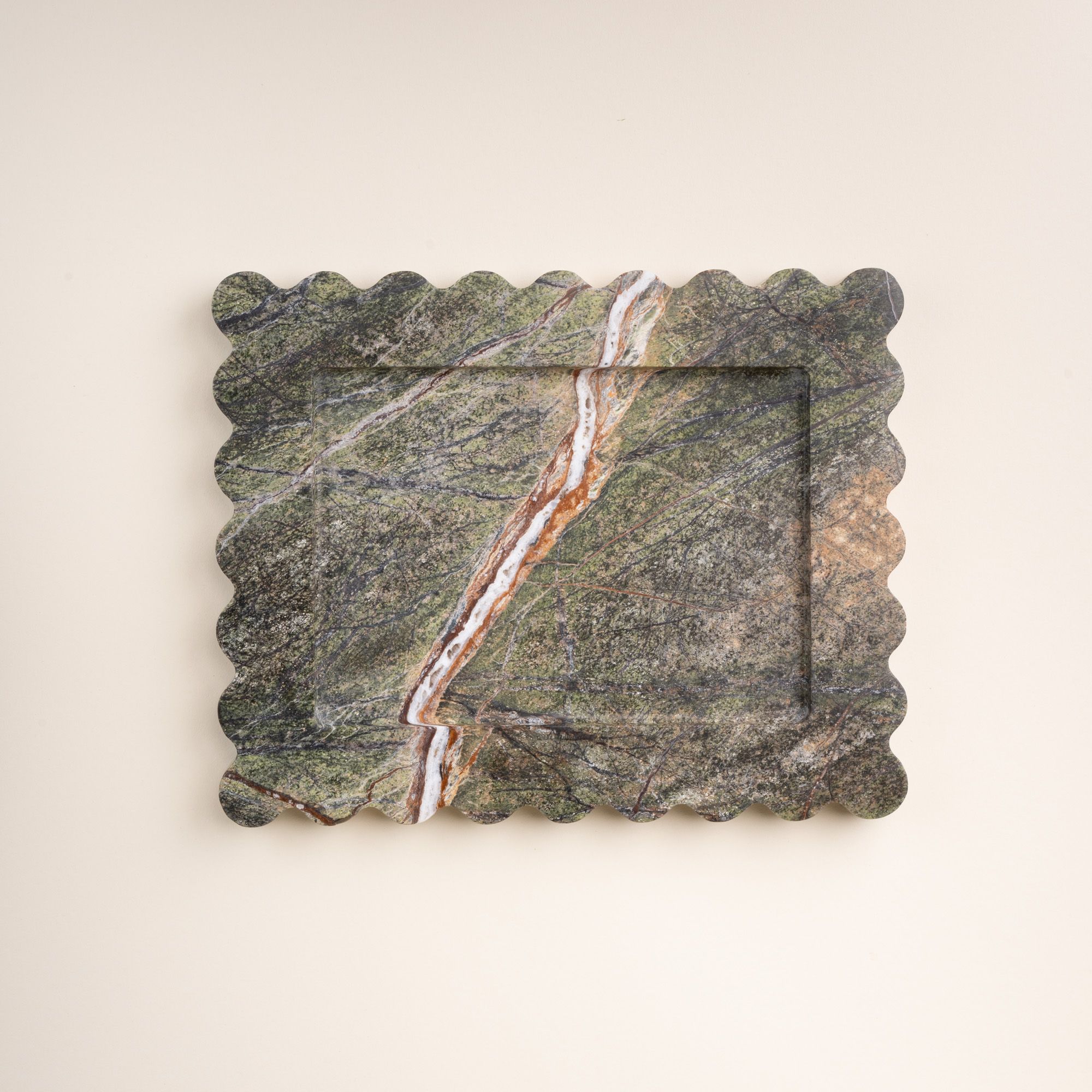 Rectangular scalloped-edge stone tray with green, brown, and white veining patterns across the surface.