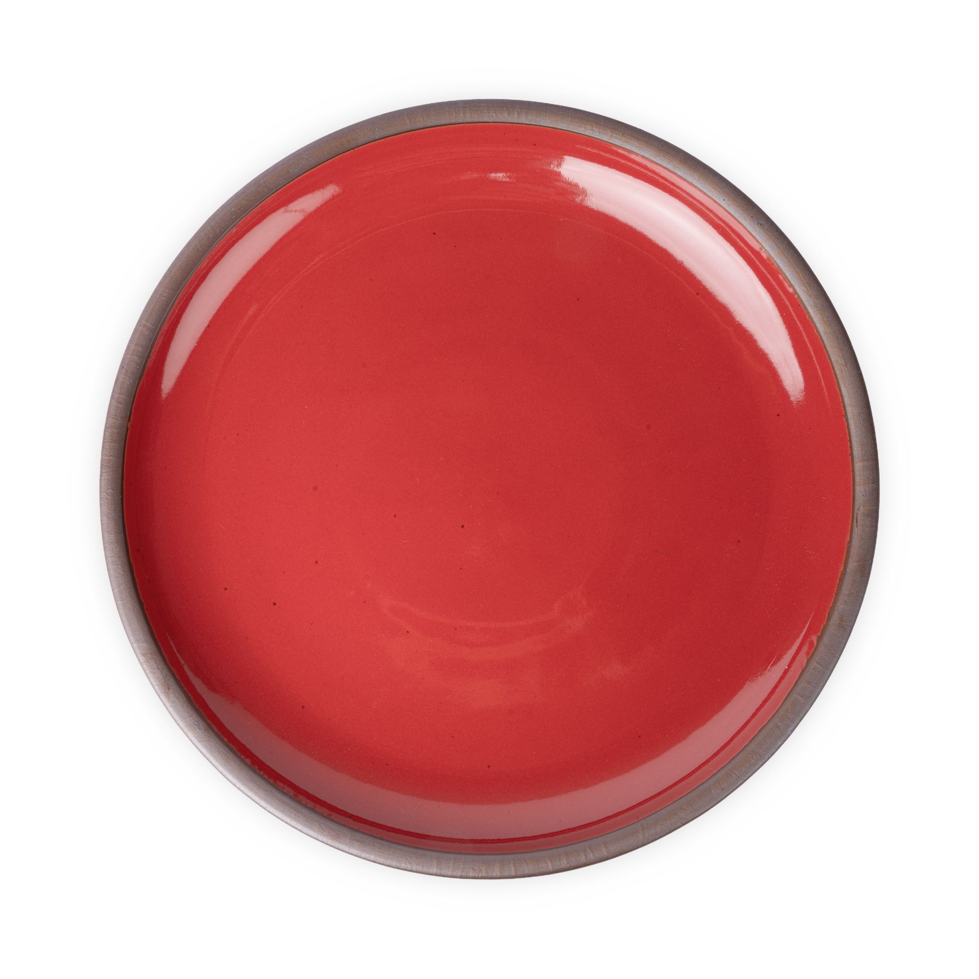 A large ceramic platter in a glossy red color featuring an unglazed rim.