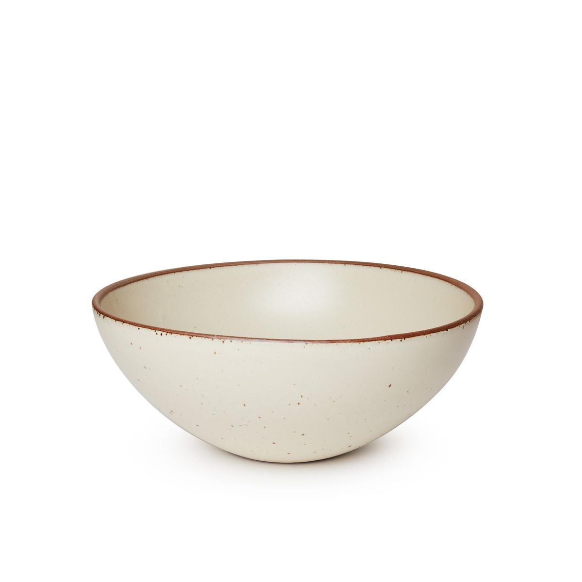 A large rounded ceramic bowl in a warm, tan-toned, off-white color featuring iron speckles and an unglazed rim