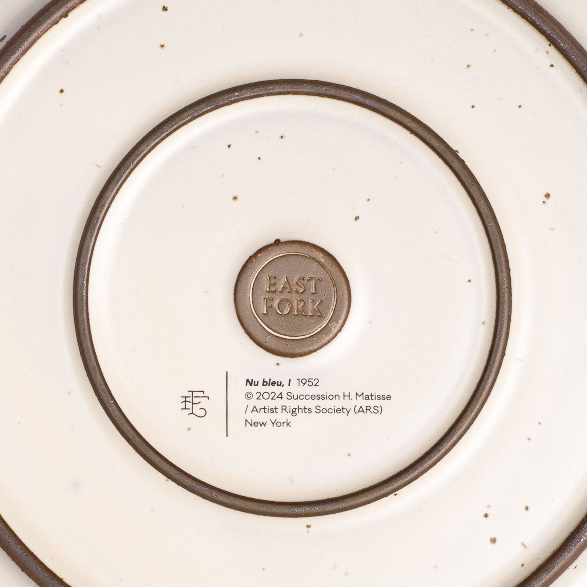 The back of the Dinner Platter with an East Fork stamp with a small decal of information about the artwork.