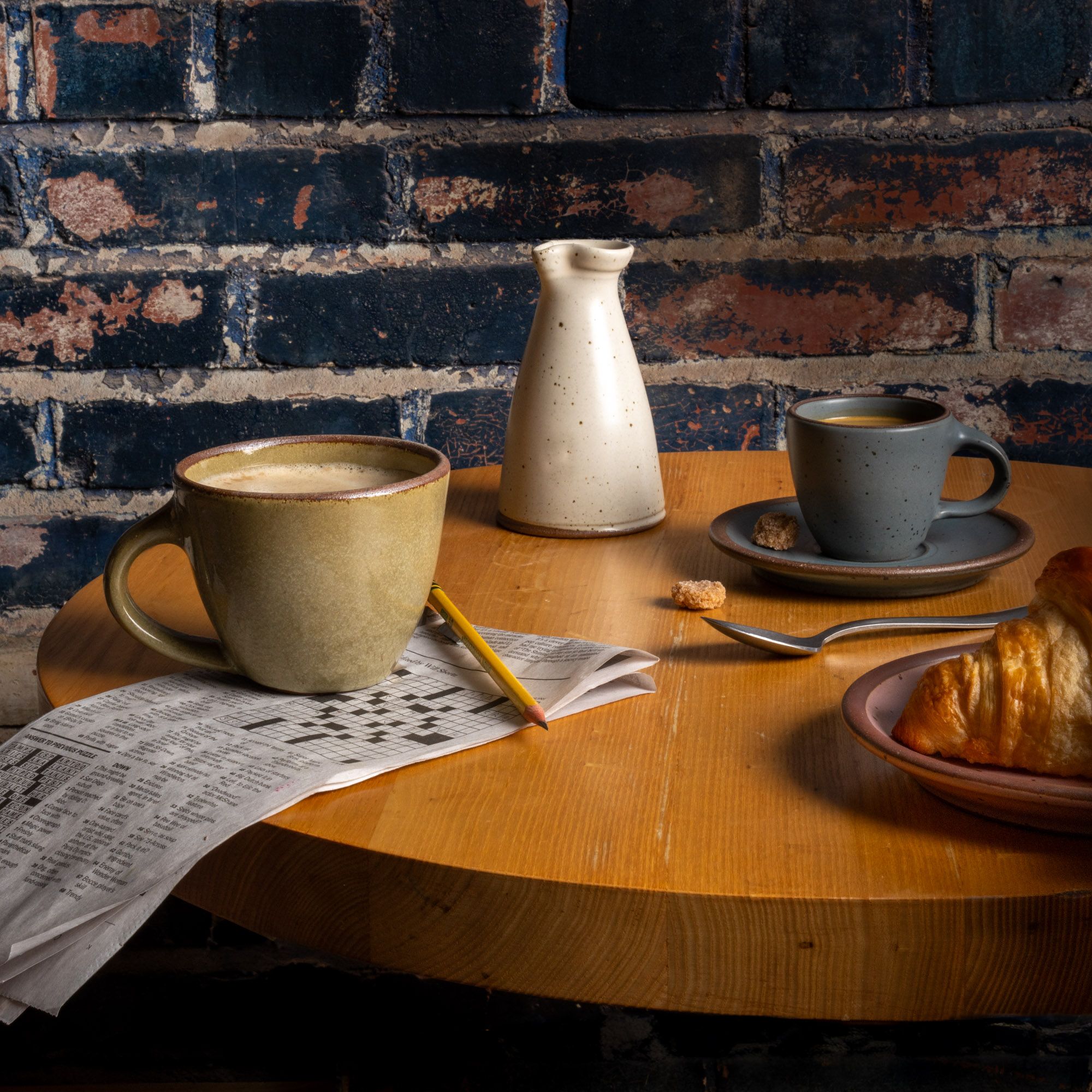 A table with East Fork Workshop pieces, The Sunday Morning Mug, The Creamer, the Espresso Cup and Saucer.