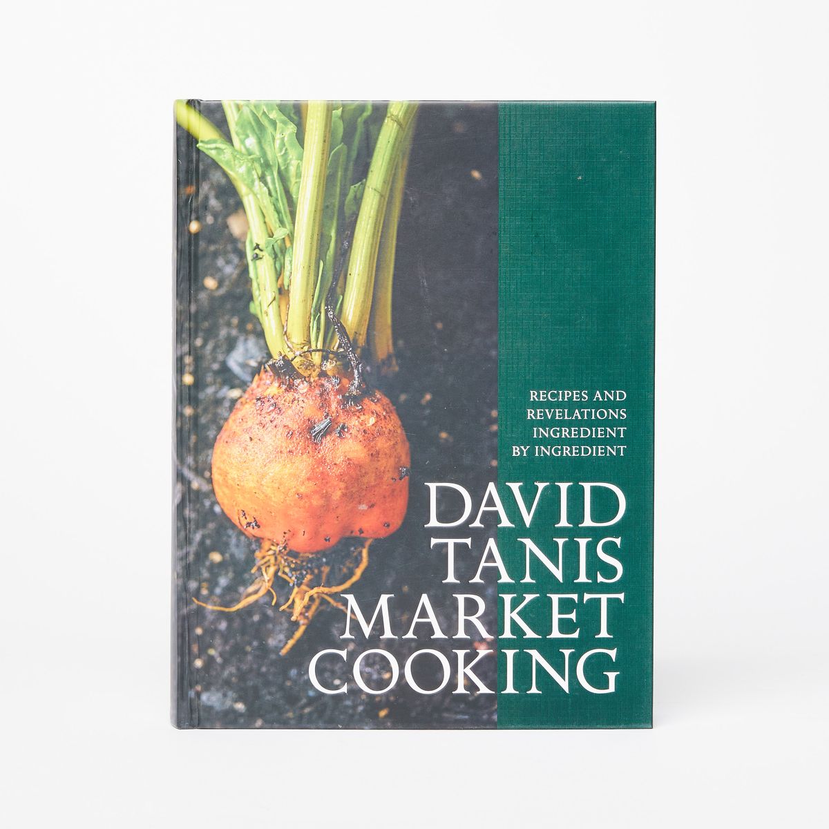 The cover of a cookbook with a picture of an orange beet with a green border on the right with the text "David Tanis Market Cooking"