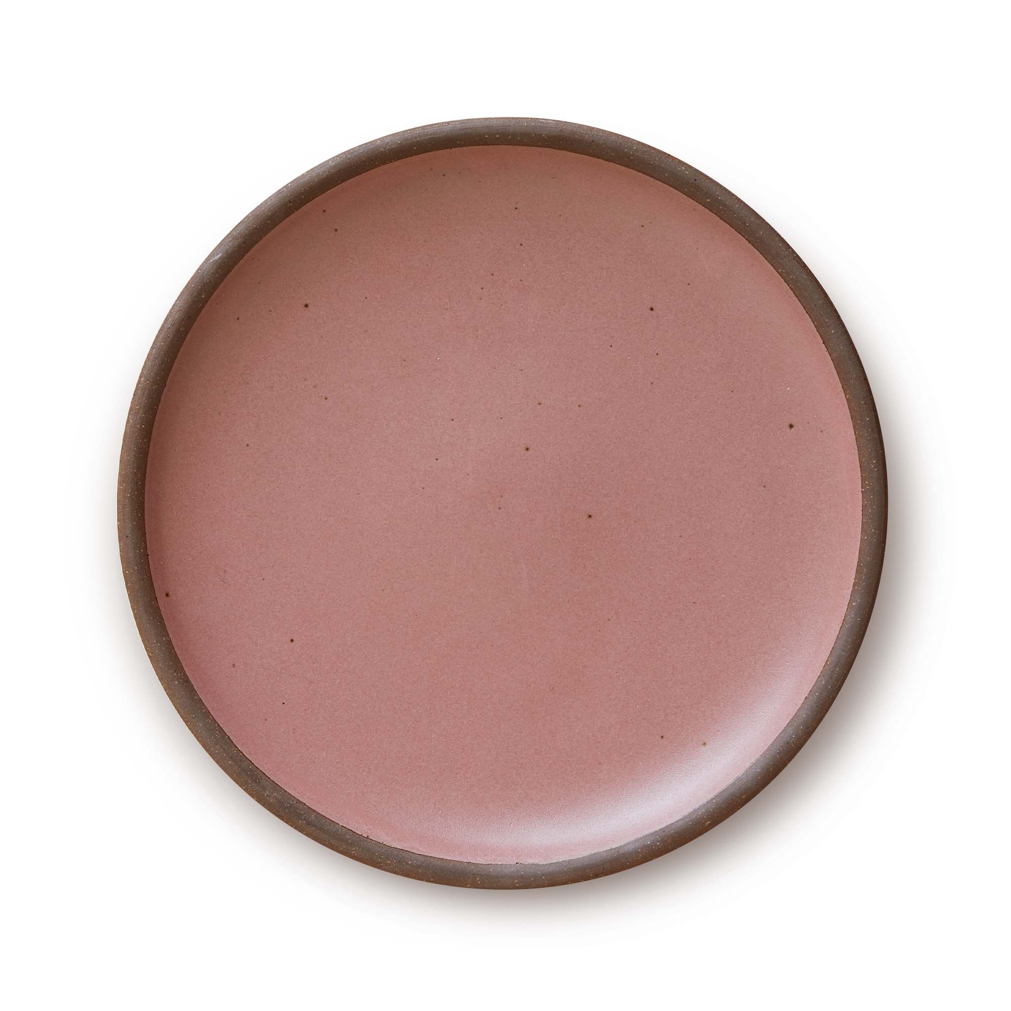 A large ceramic platter in a soft rosey pink color featuring iron speckles and an unglazed rim.