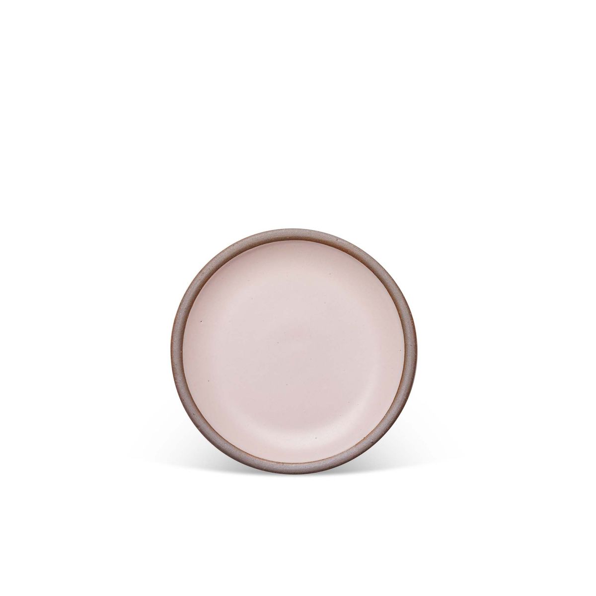 A dessert sized ceramic plate in a soft light pink color featuring iron speckles and an unglazed rim