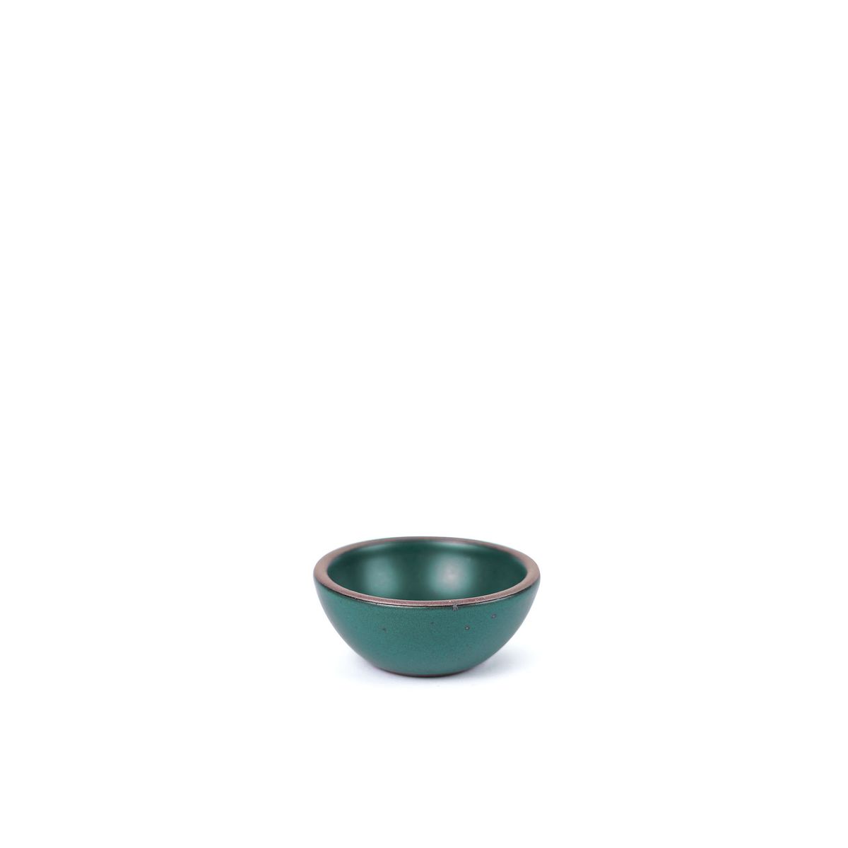 A tiny rounded ceramic bowl in a deep dark teal color featuring iron speckles and an unglazed rim