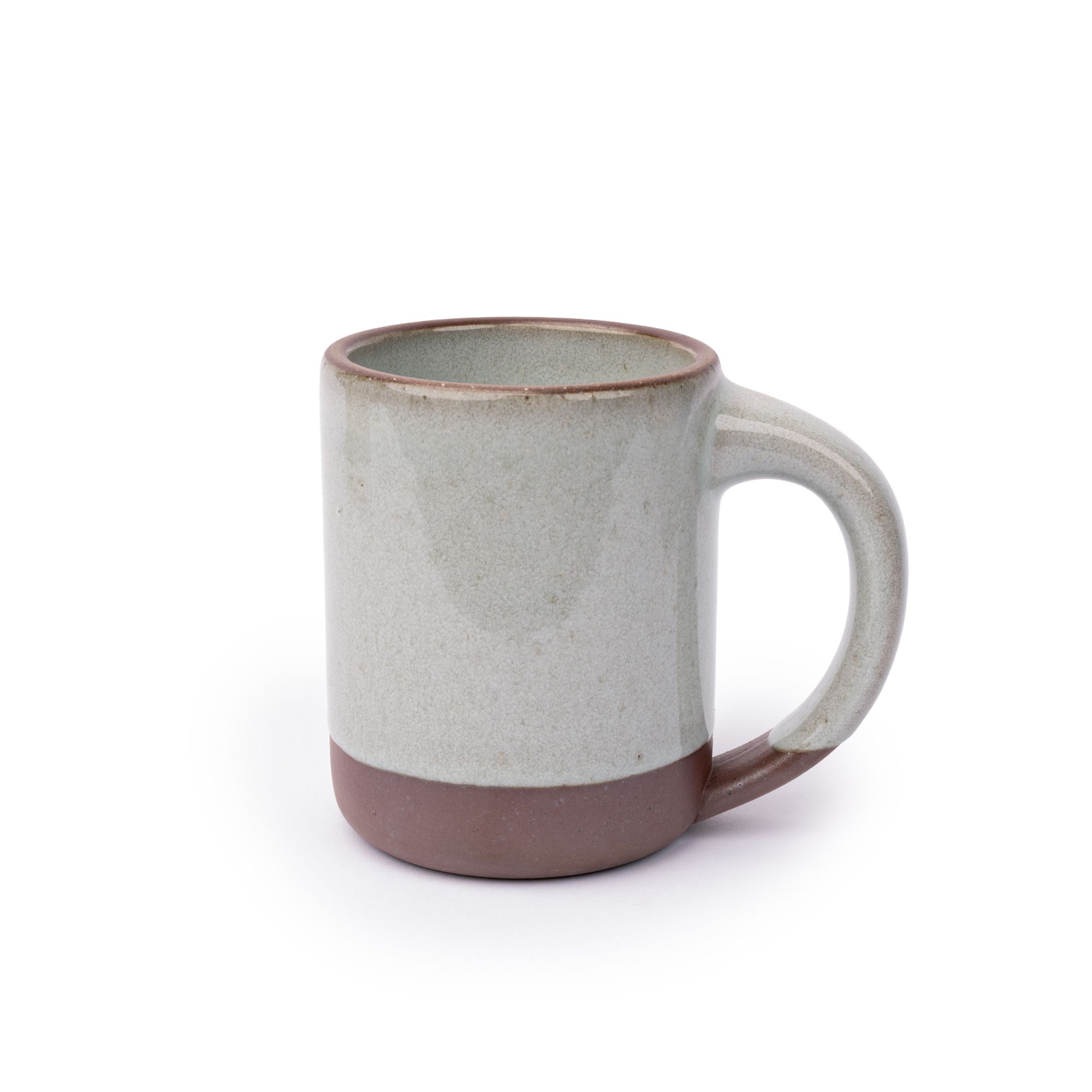 A big sized ceramic mug with handle in a reflective icy off-white color featuring iron speckles and unglazed rim and bottom base.