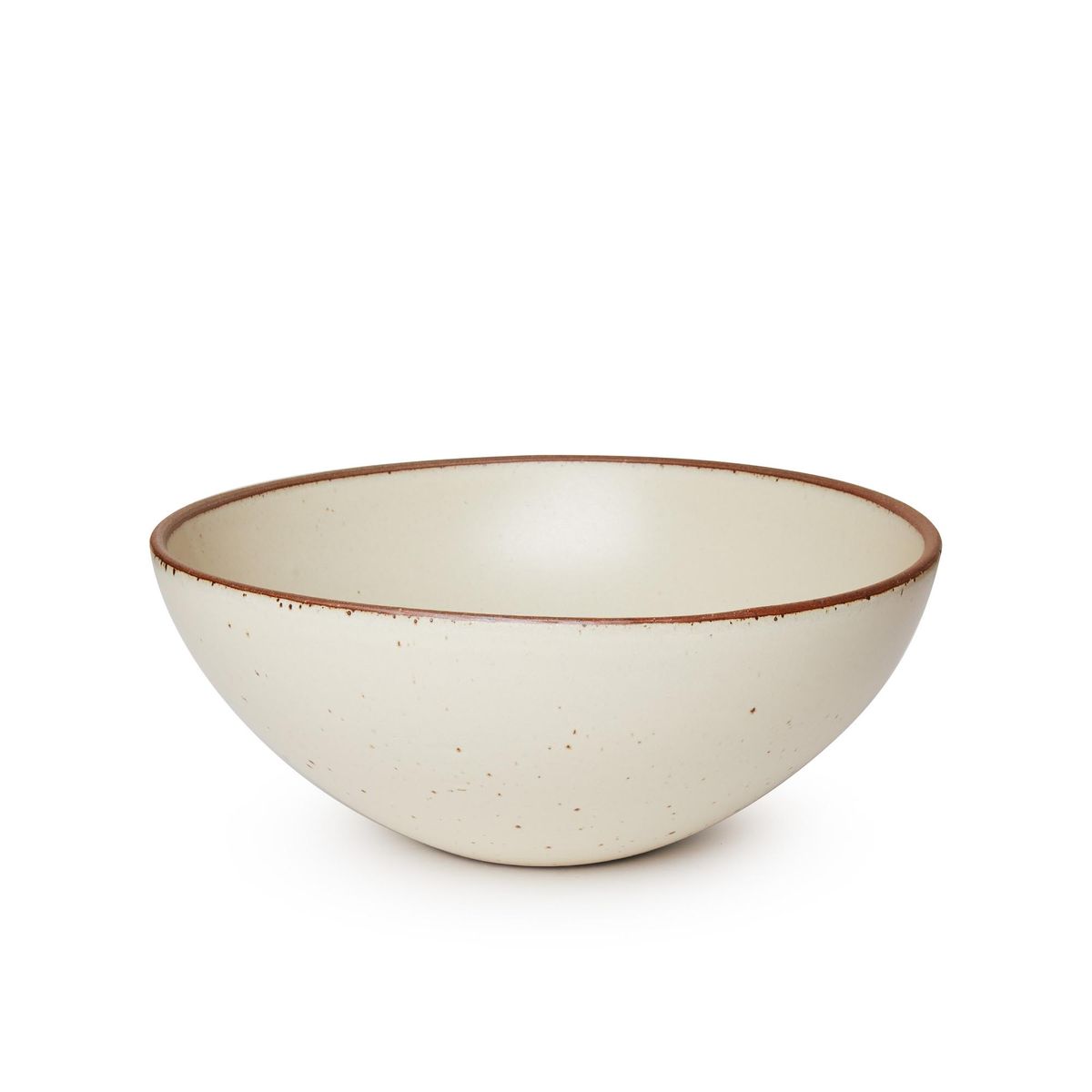 A large ceramic mixing bowl in a warm, tan-toned, off-white color featuring iron speckles and an unglazed rim