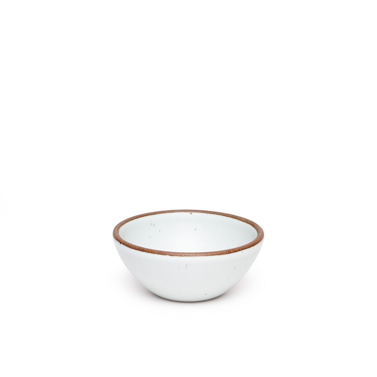 A small dessert sized rounded ceramic bowl in a cool white color featuring iron speckles and an unglazed rim