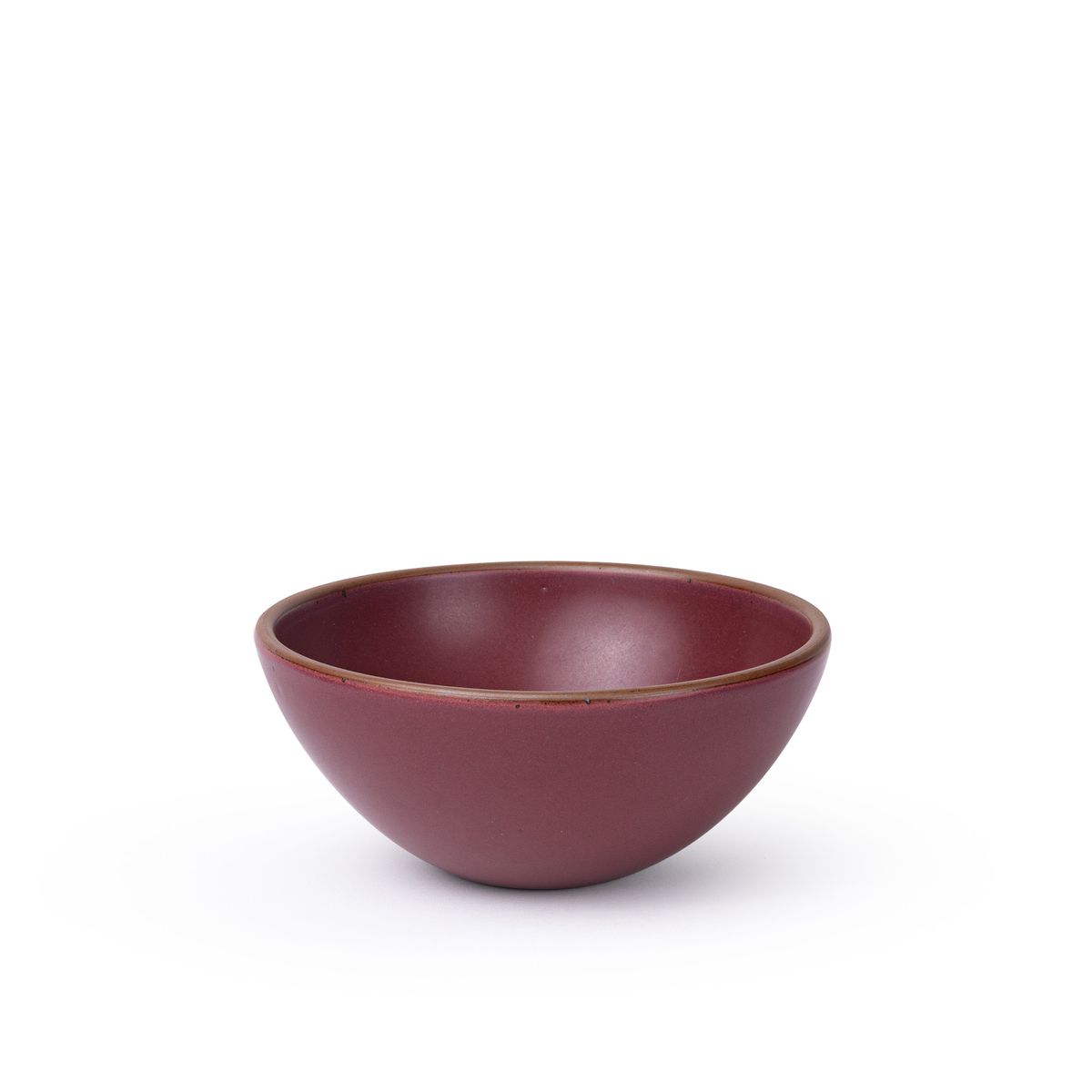 A medium rounded ceramic bowl in a plum color featuring iron speckles and an unglazed rim