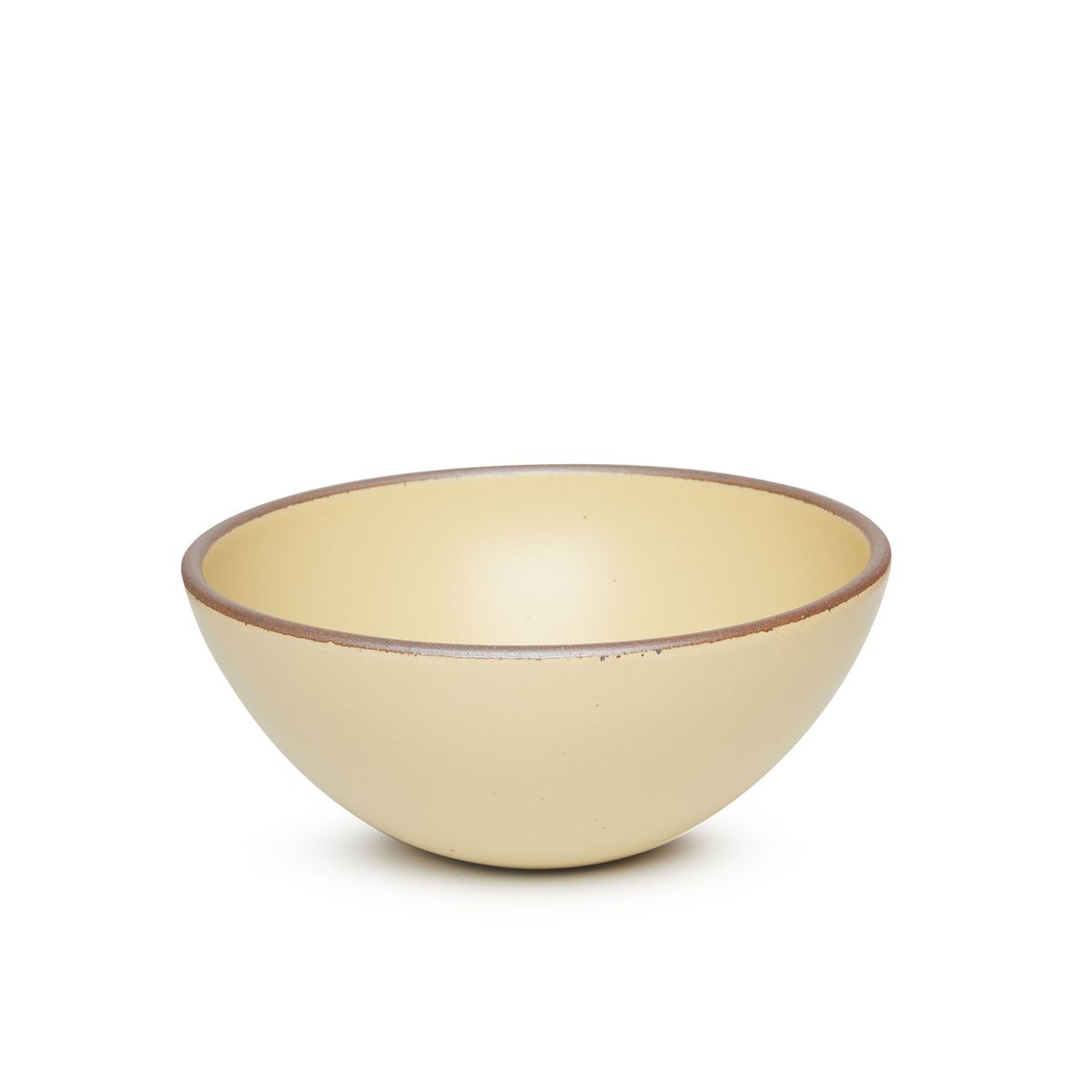 A large rounded ceramic bowl in a light butter yellow color featuring iron speckles and an unglazed rim