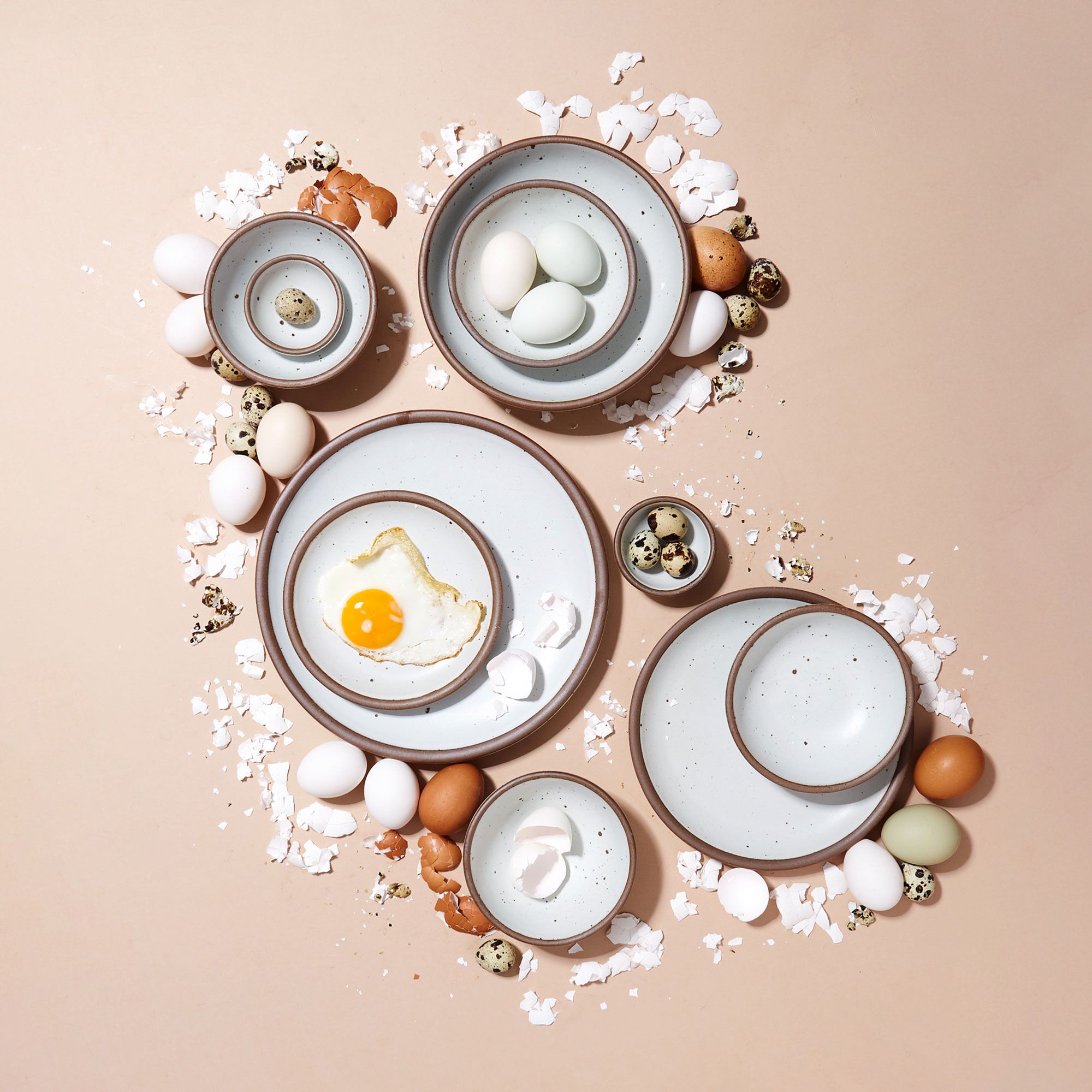 Eggshell plates and bowls with cooked and broken eggs