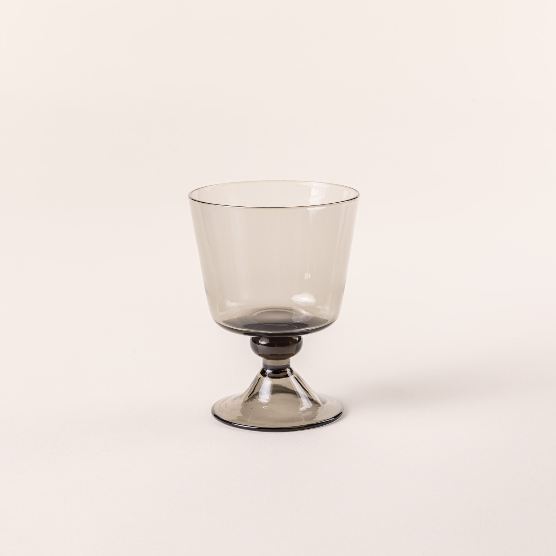 A short wine glass with an angular cup and grey color