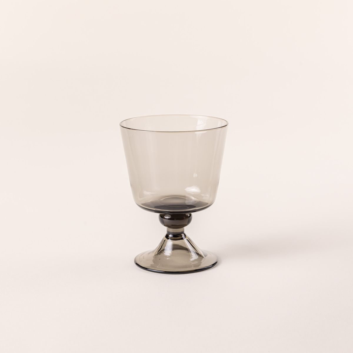 A short wine glass with an angular cup and grey color