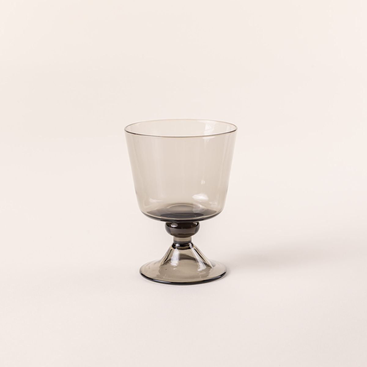 A short wine glass with an angular cup and grey color