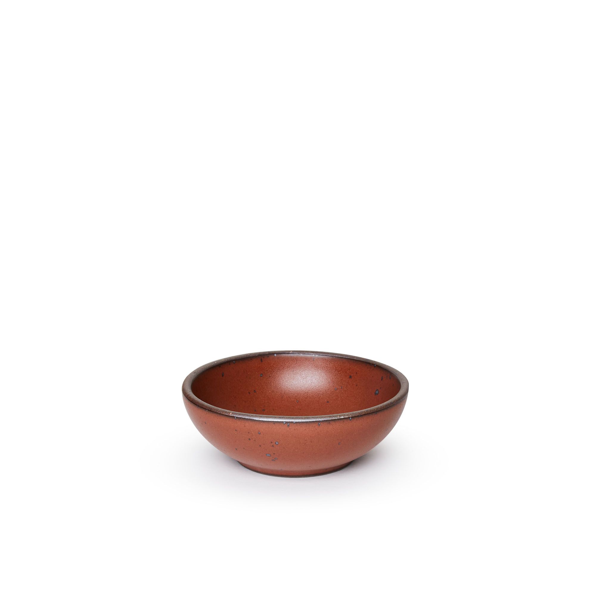 A small shallow ceramic bowl in a cool burnt terracotta color featuring iron speckles and an unglazed rim