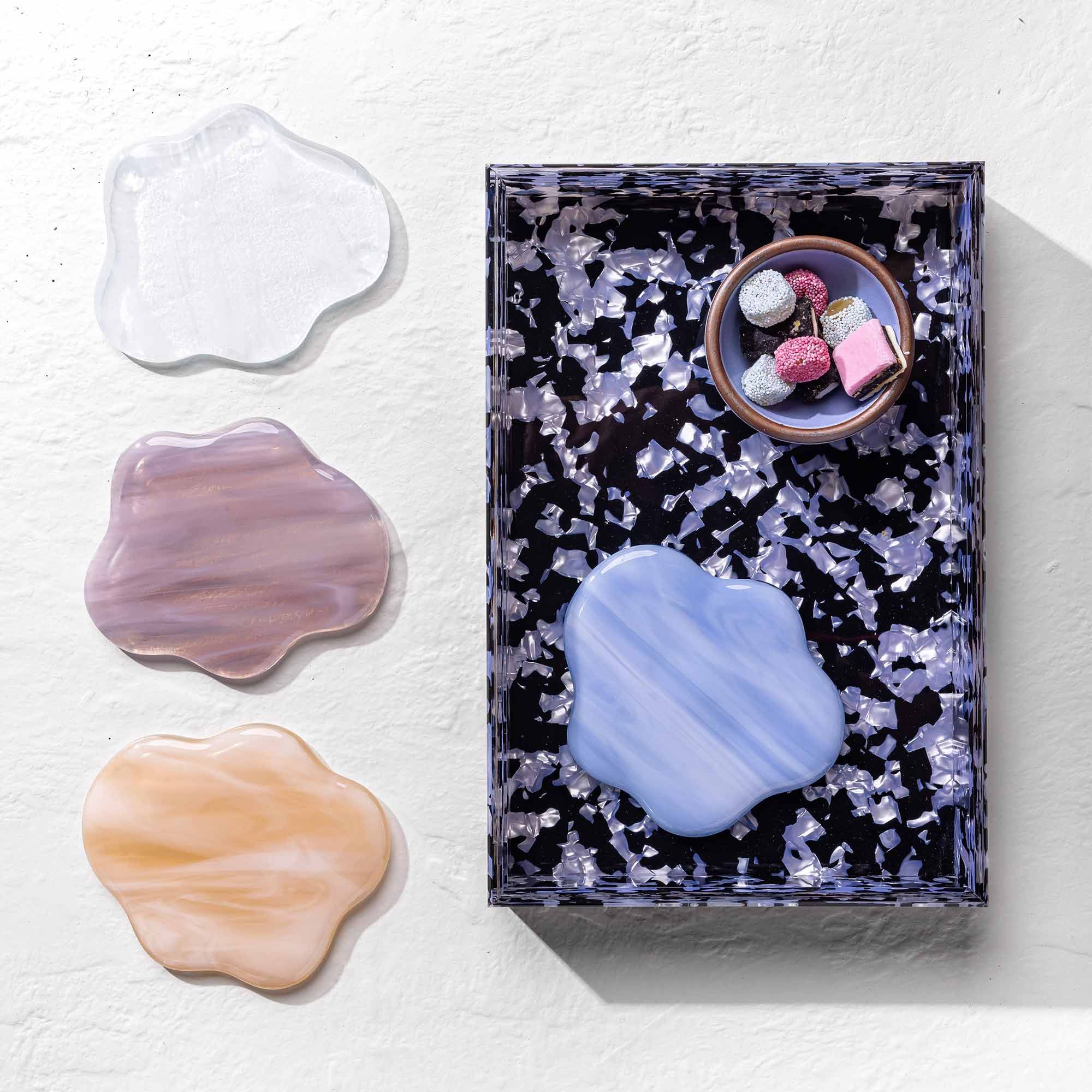 4 glass coasters shaped like clouds in dreamy colors with an acrylic tray and small bowl.