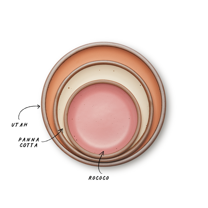 A stack of 3 plates in Dinner, Side, and Cake sizes in a peach, warm off-white, and pink colors.