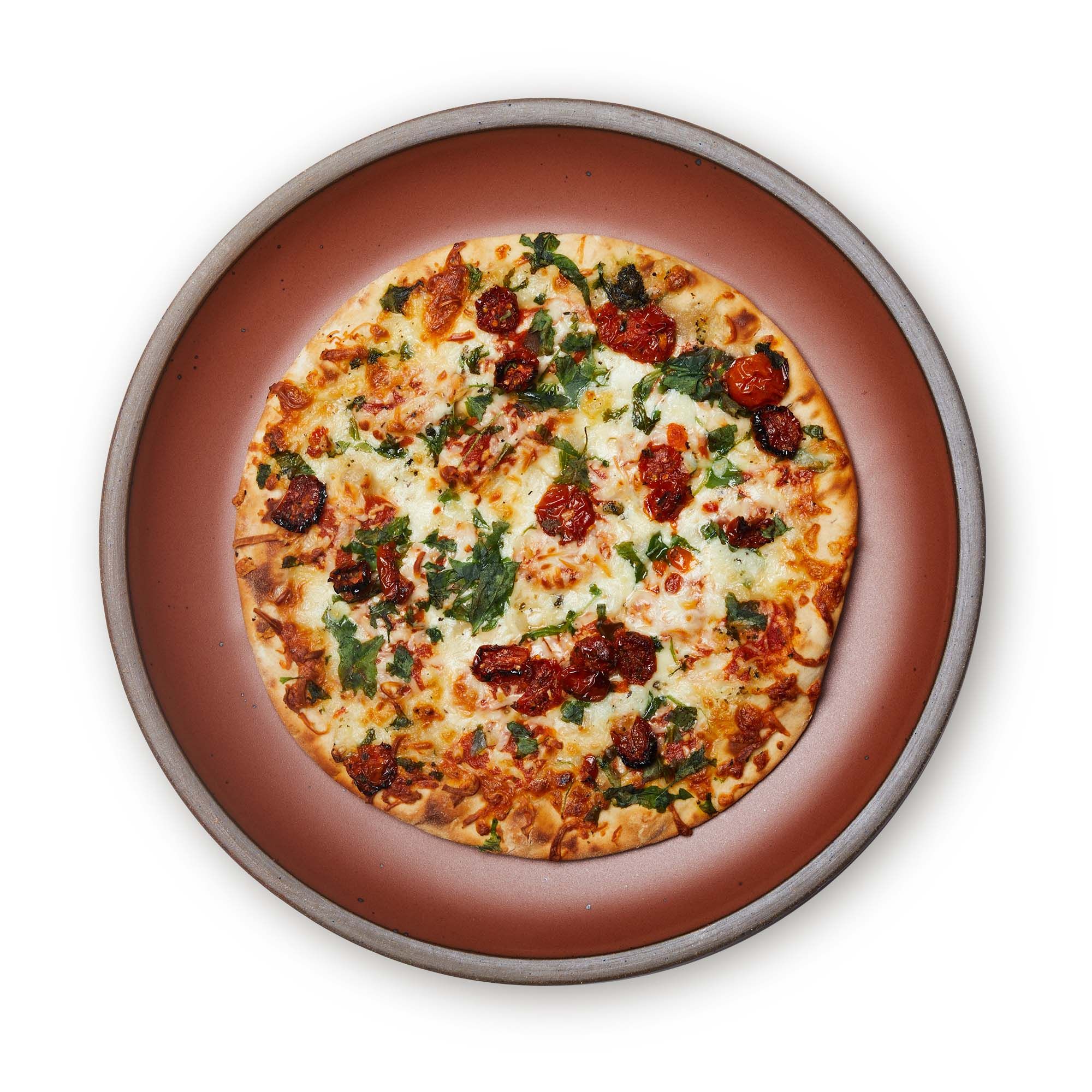 Pizza on a large ceramic platter in a cool burnt terracotta color featuring iron speckles and an unglazed rim