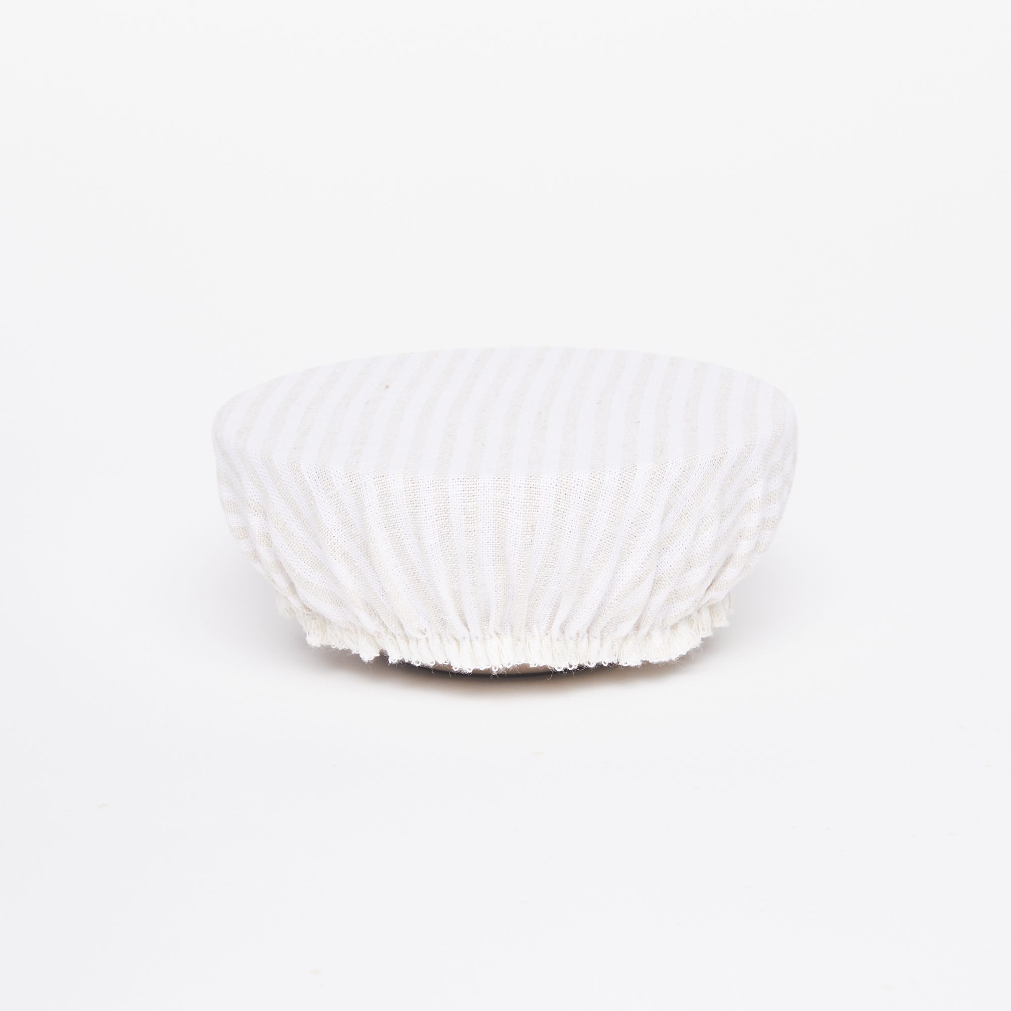 Mixing bowl with white linen bowl cover with thin beige stripes