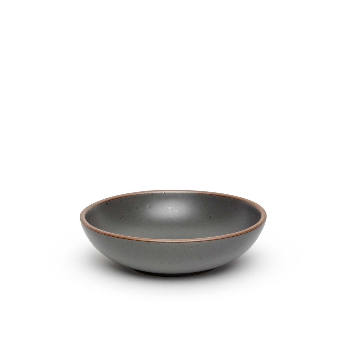 A dinner-sized shallow ceramic bowl in a cool, medium grey color featuring iron speckles and an unglazed rim