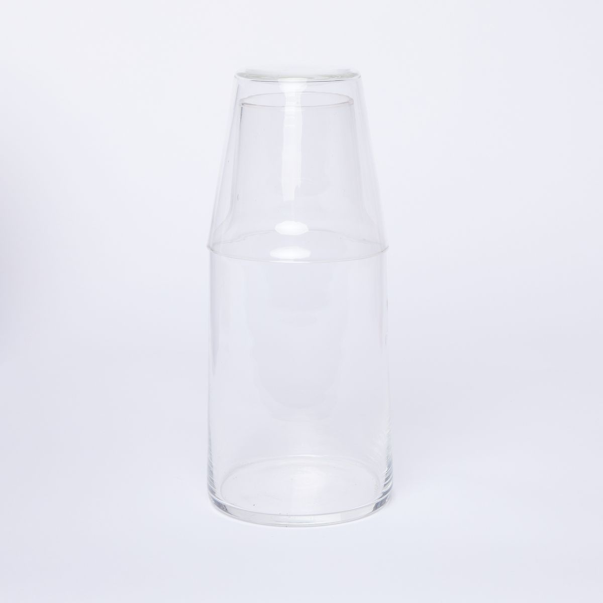 Clear glass carafe with clear glass stacked on top