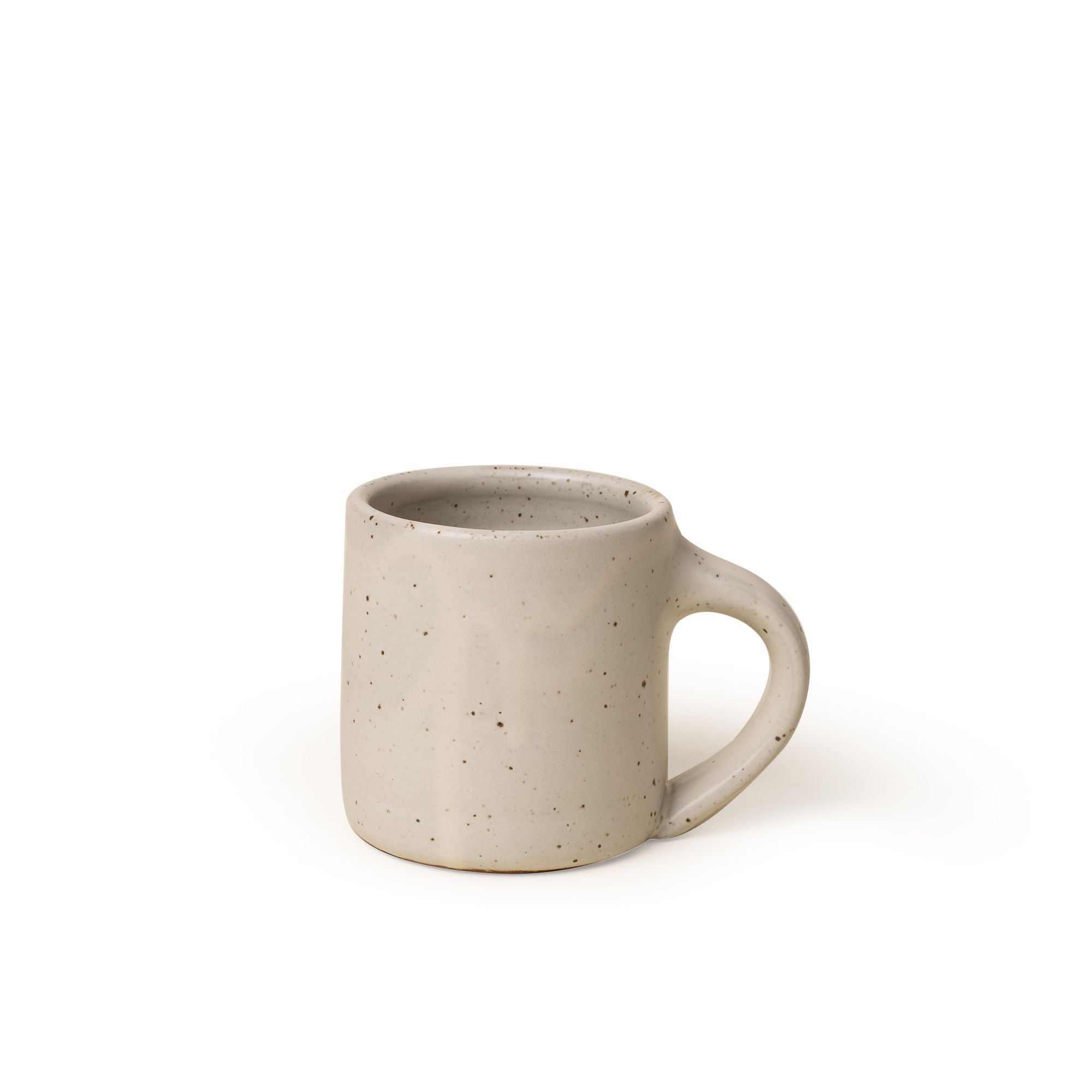 A medium sized ceramic mug with handle in a warm, tan-toned, off-white color featuring iron speckles
