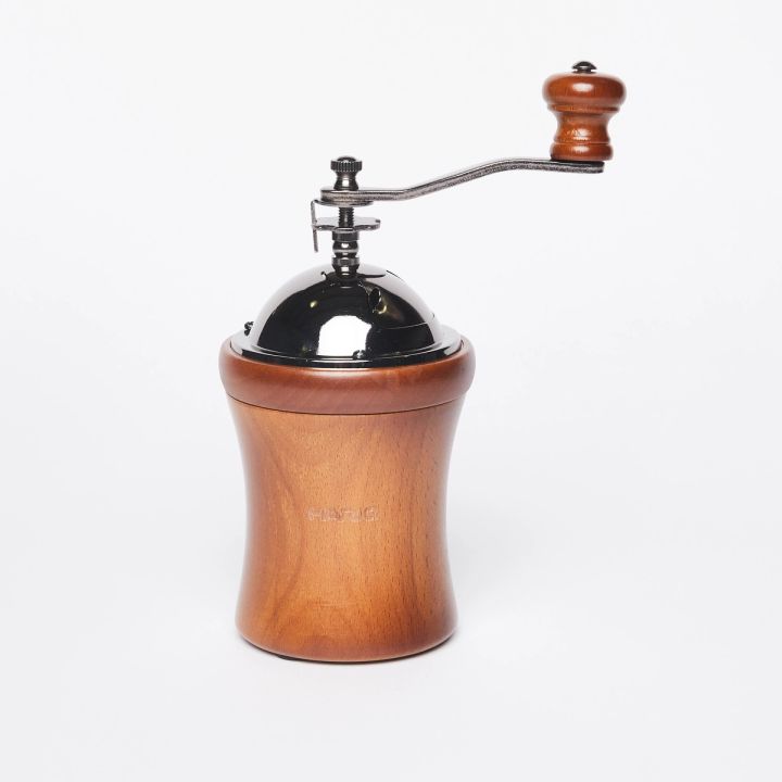 Wide hourglass shaped wood base with metal domed top and handle with a wood knob