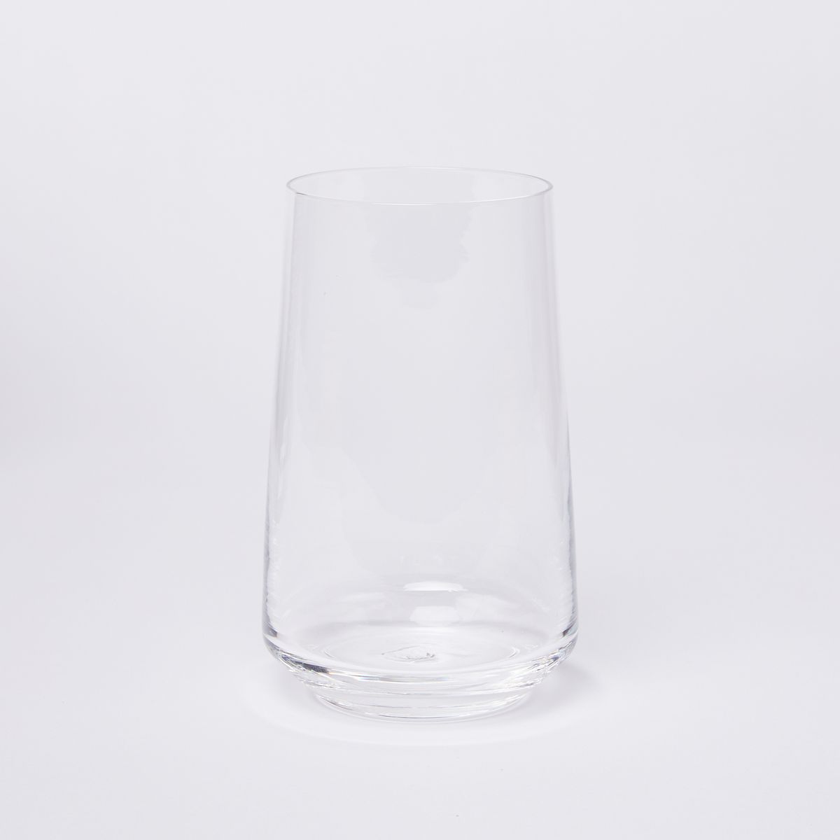 A clear round glass that tapers towards the rim