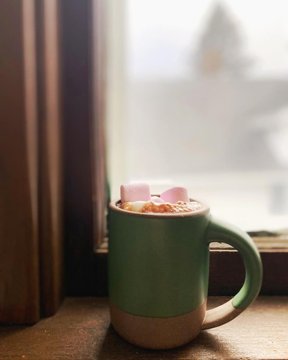 An East Fork Mug in Orchard photographed by a kitchen window and full of hot chocolate and pink marshmallows. How fun?!