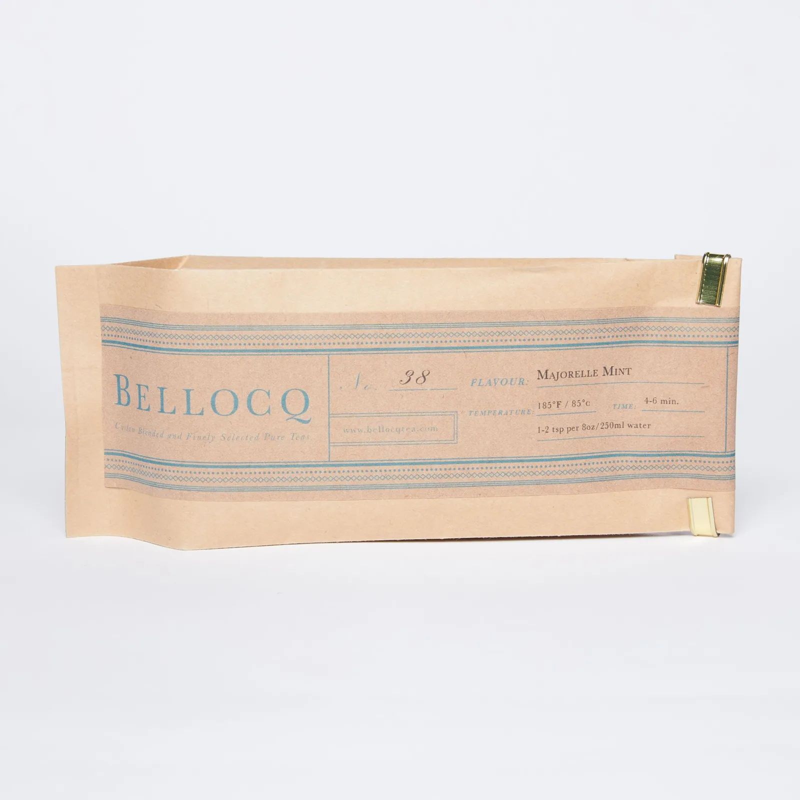 A tan bag of tea with delicate blue text and design
