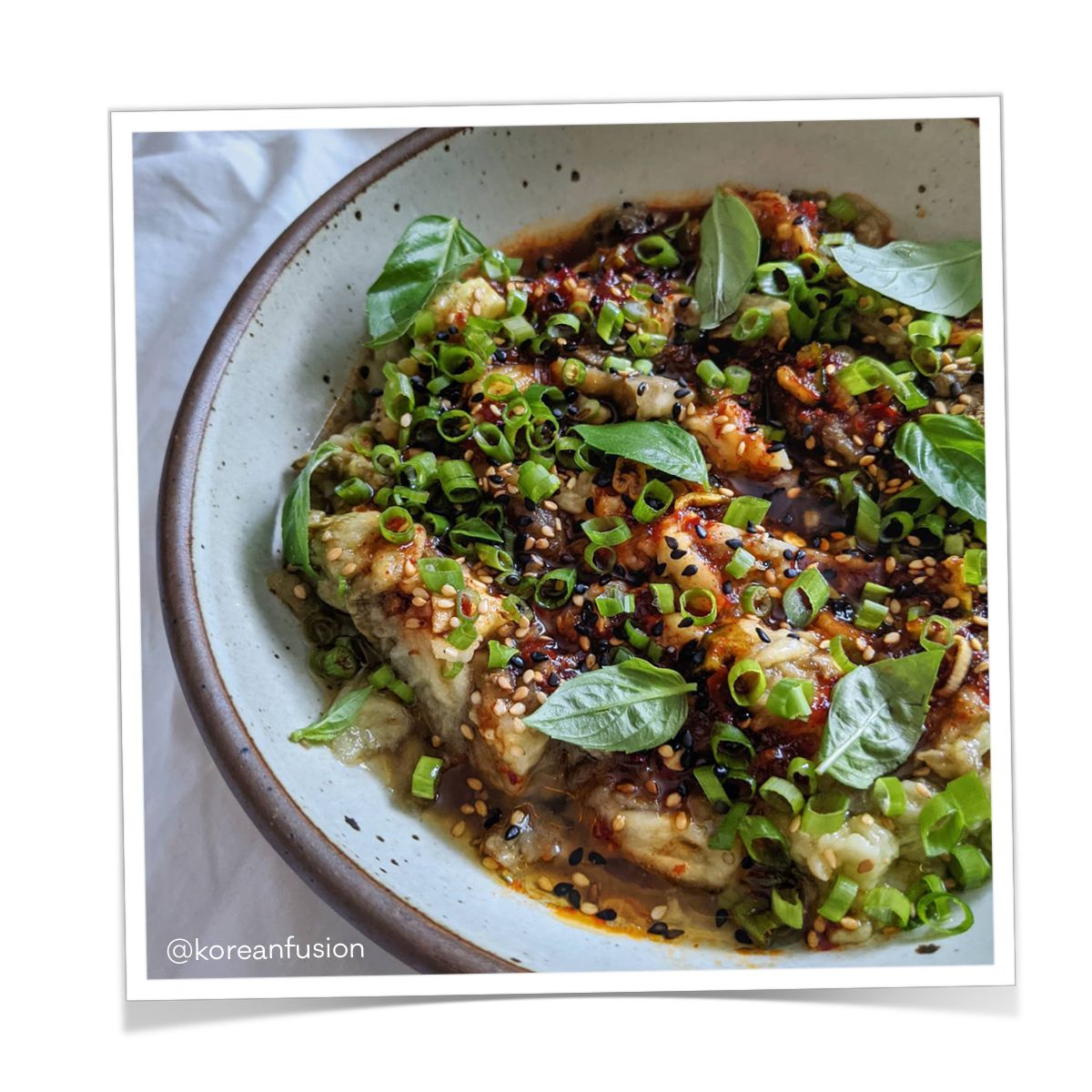 Colorful entree dish inside a white coupe plate.
