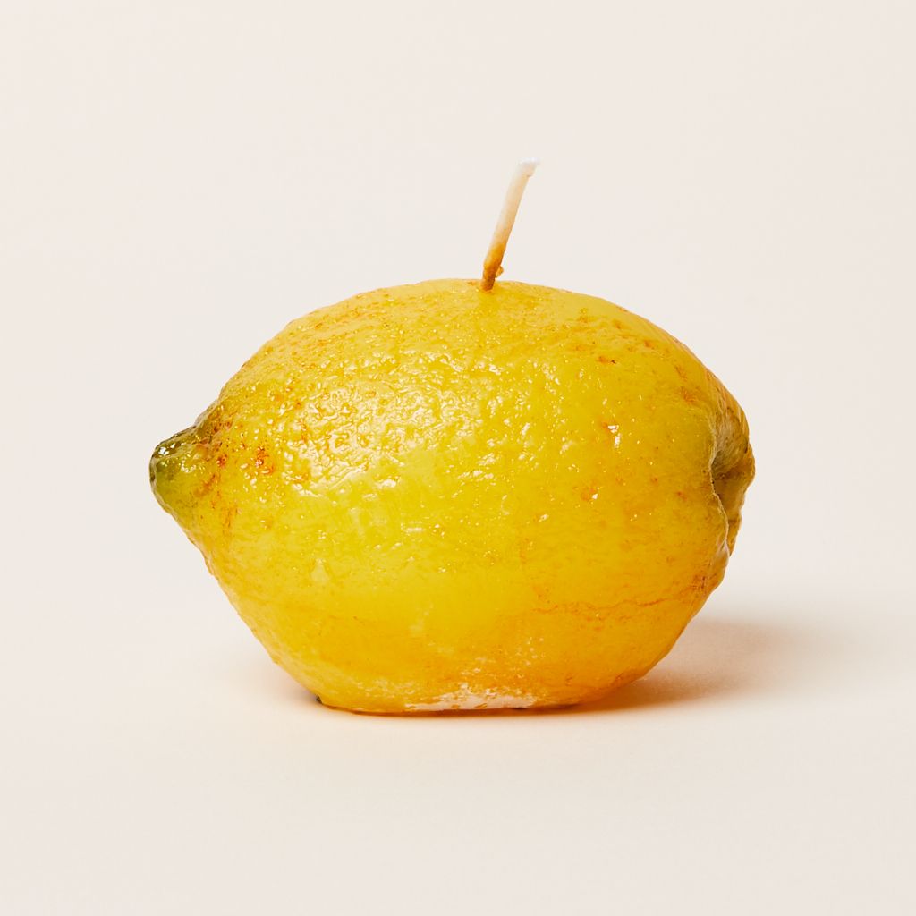 An ovoid yellow candle shaped and textured to mimic a lemon