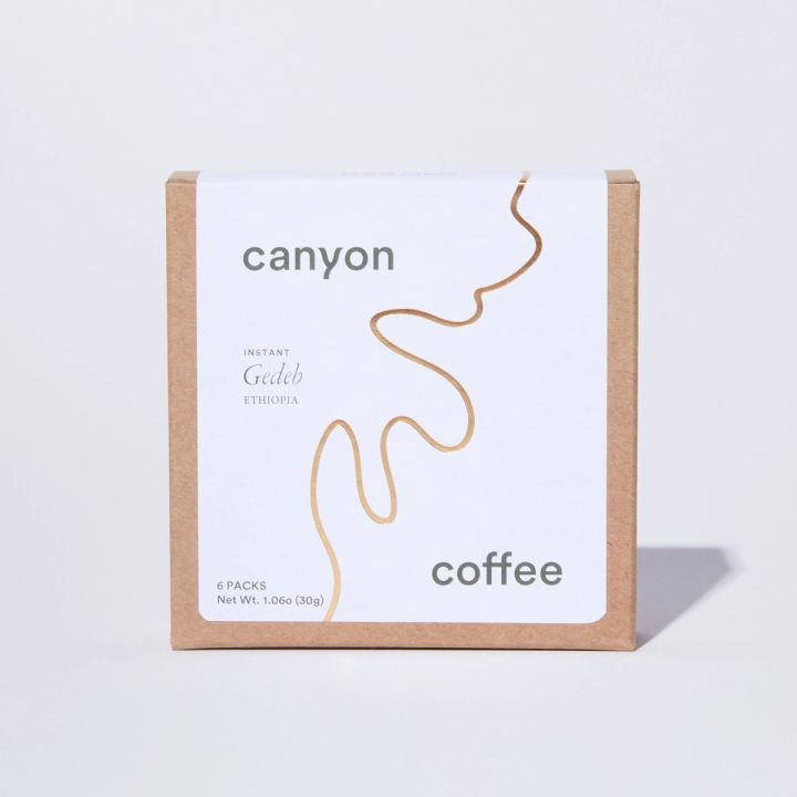 Brown box with square white label with gold squiggly line running diagonally from top to bottom and 'Canyon' in top left corner, 'Coffee' in bottom right corner.