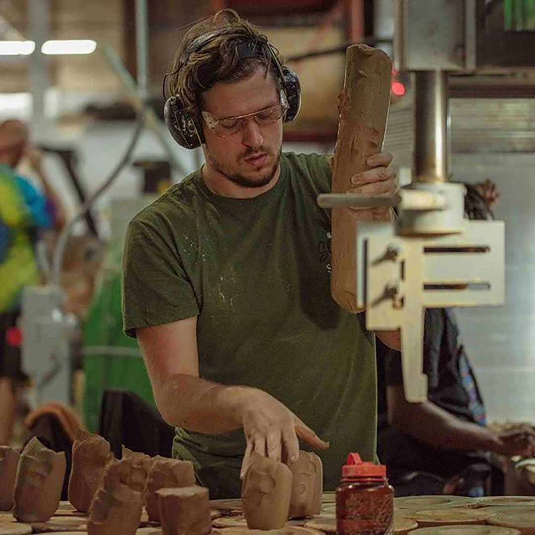 East Fork employee working with clay in East Fork Factory