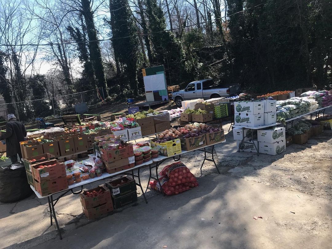 Stacks of fresh produce on folding tables outside