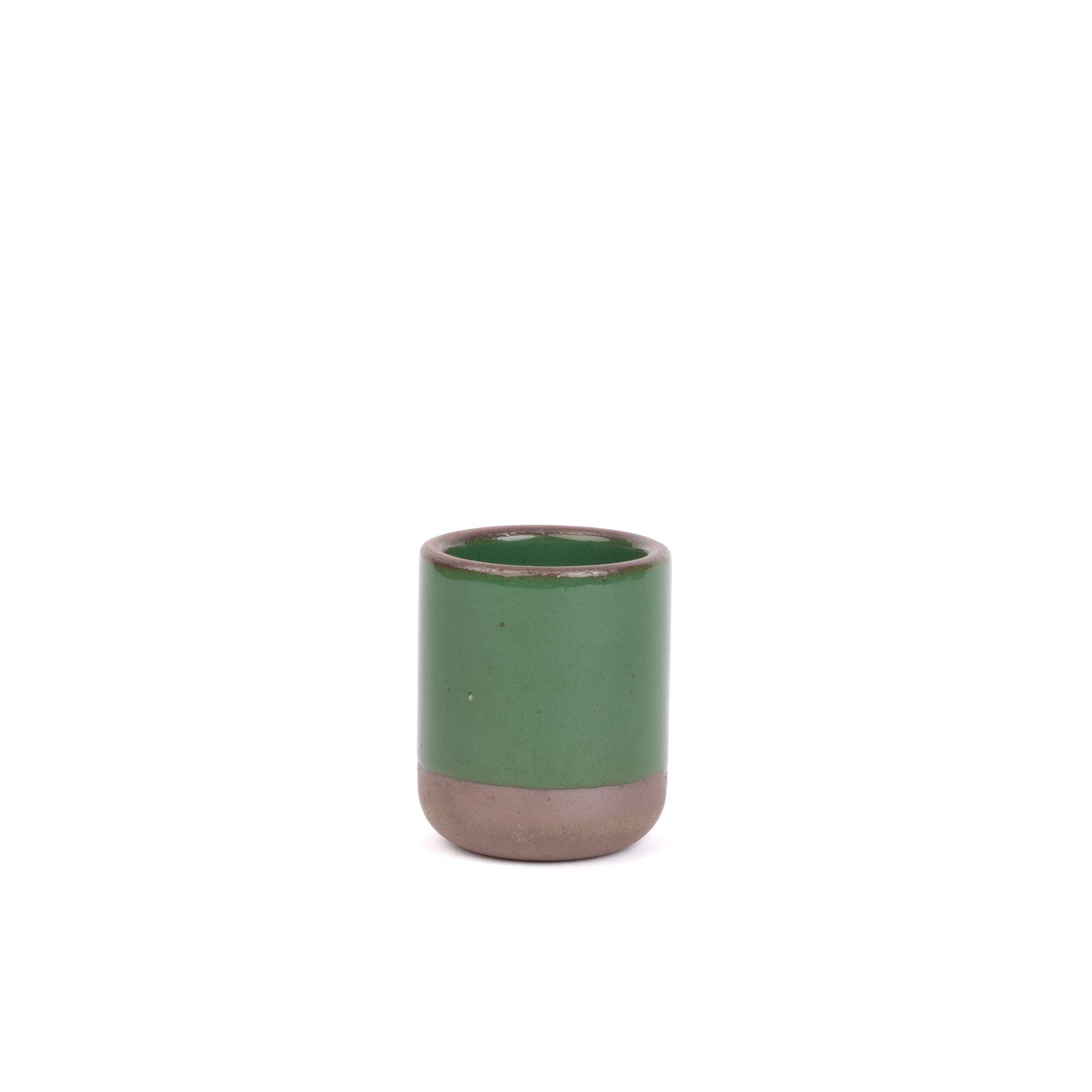 A small, short ceramic mug cup in a glossy emerald green color featuring iron speckles and unglazed rim and bottom base.