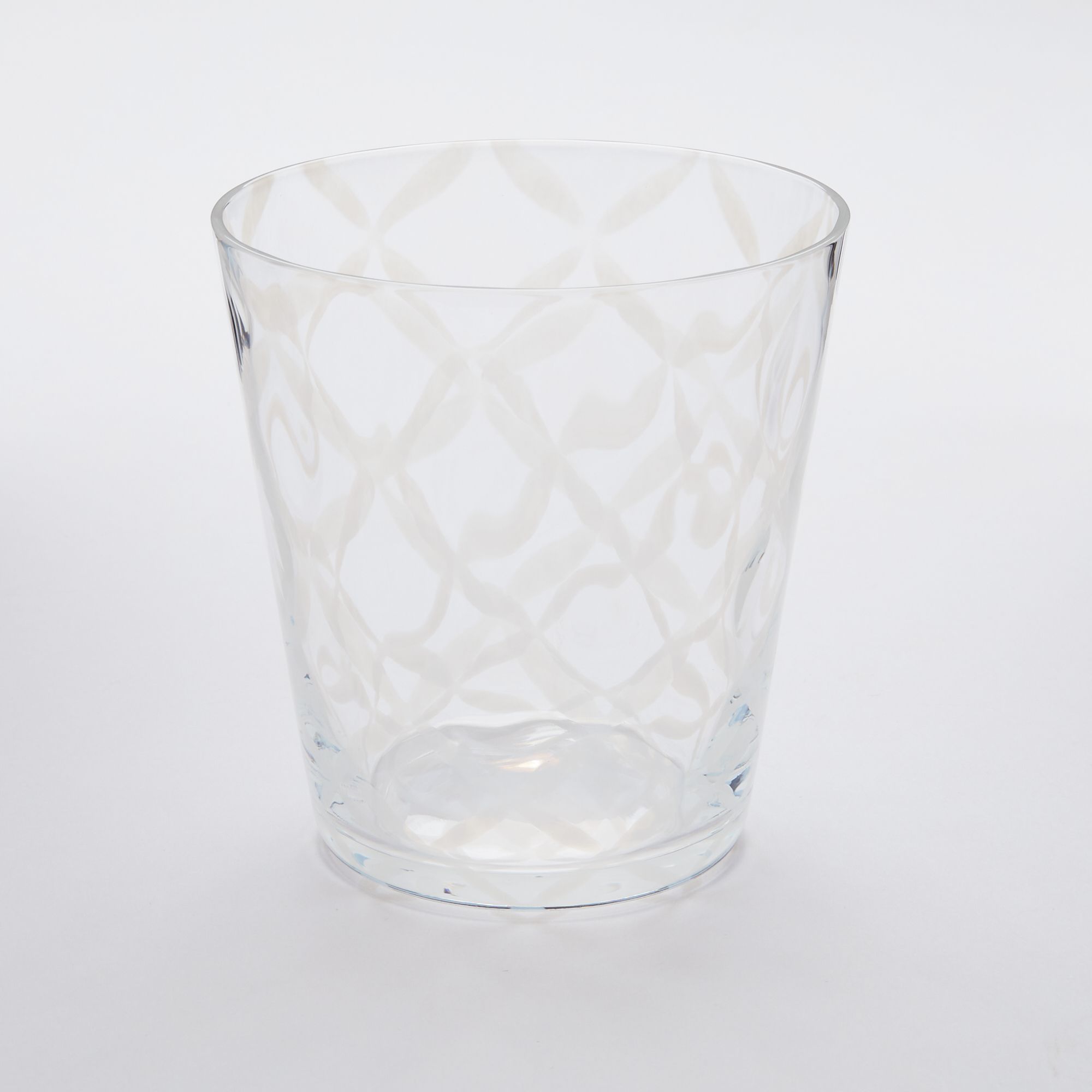 A short clear glass with a delicate grid pattern