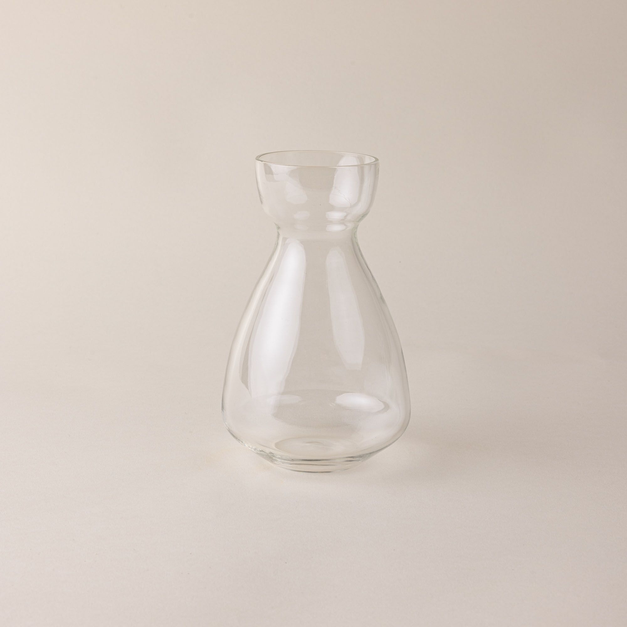 A clear simple sculptural glass bulb vase.