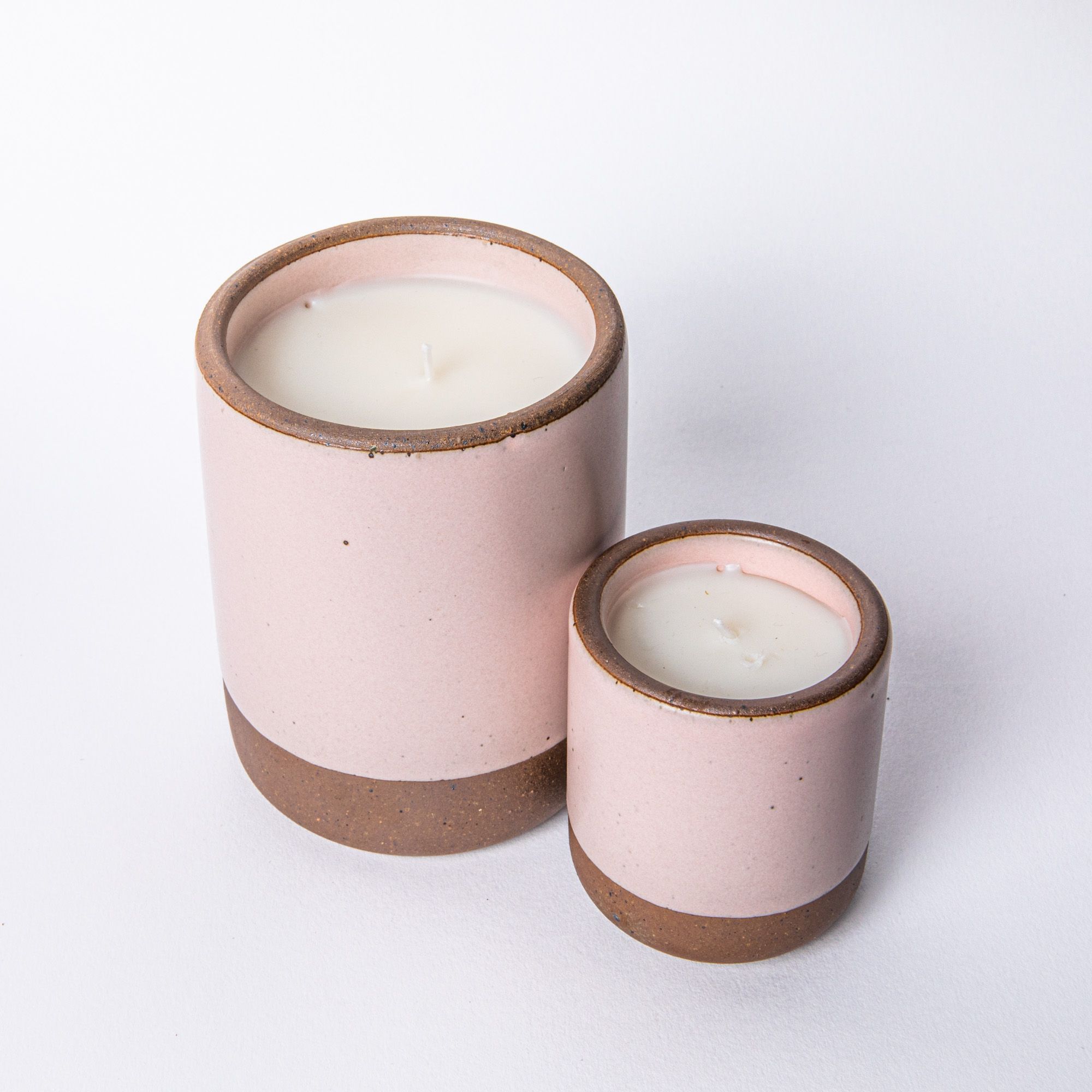 Large and Small ceramic vessel in soft light pink color with candle inside