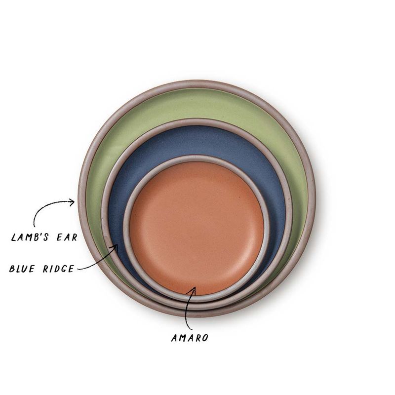 3 stacked ceramic plates in a calming sage, a muted navy, and a terracotta color