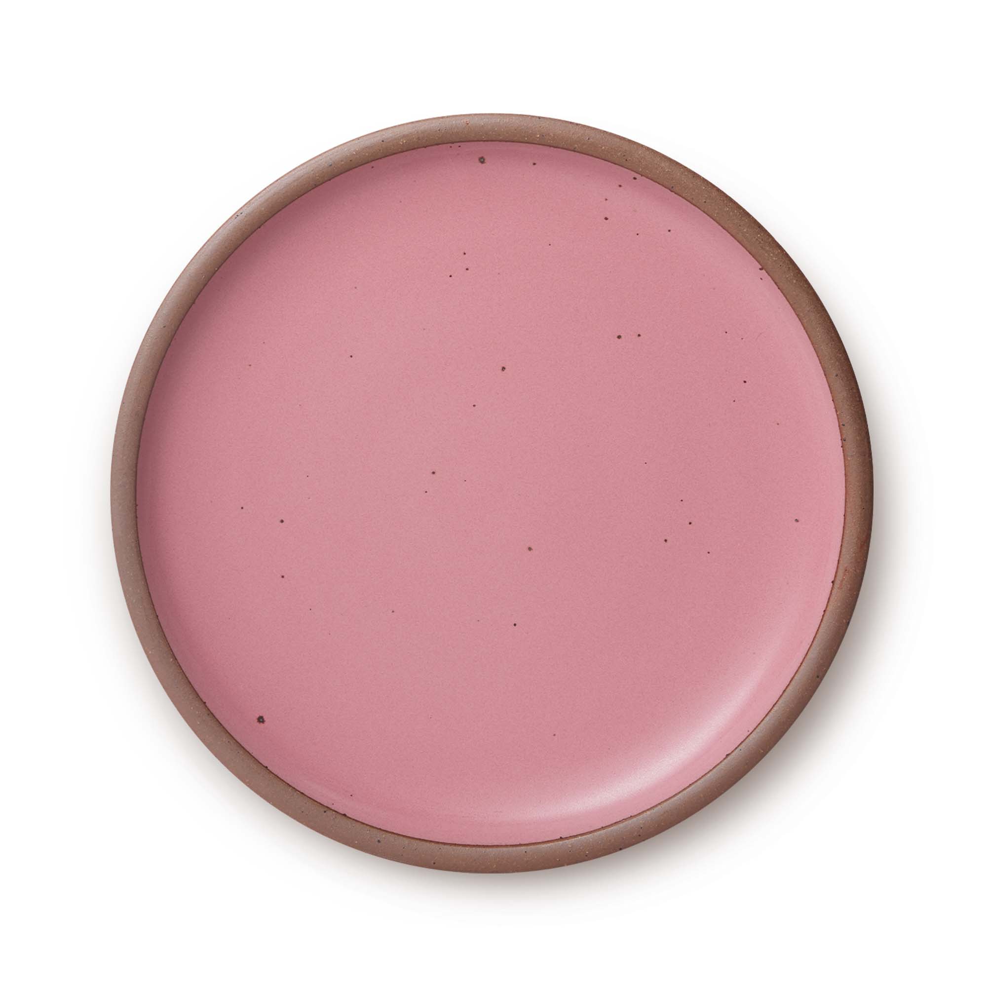 A large ceramic platter in a pink color featuring iron speckles and an unglazed rim.