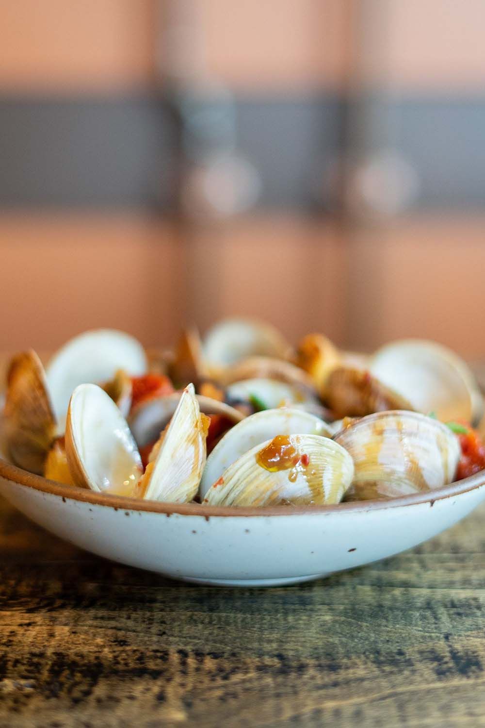 Clams in East Fork Everyday Bowl in Eggshell with blurred background