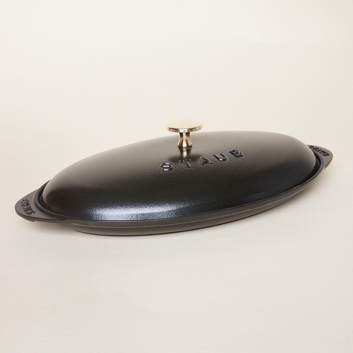 black oval platter with lid and gold handle 