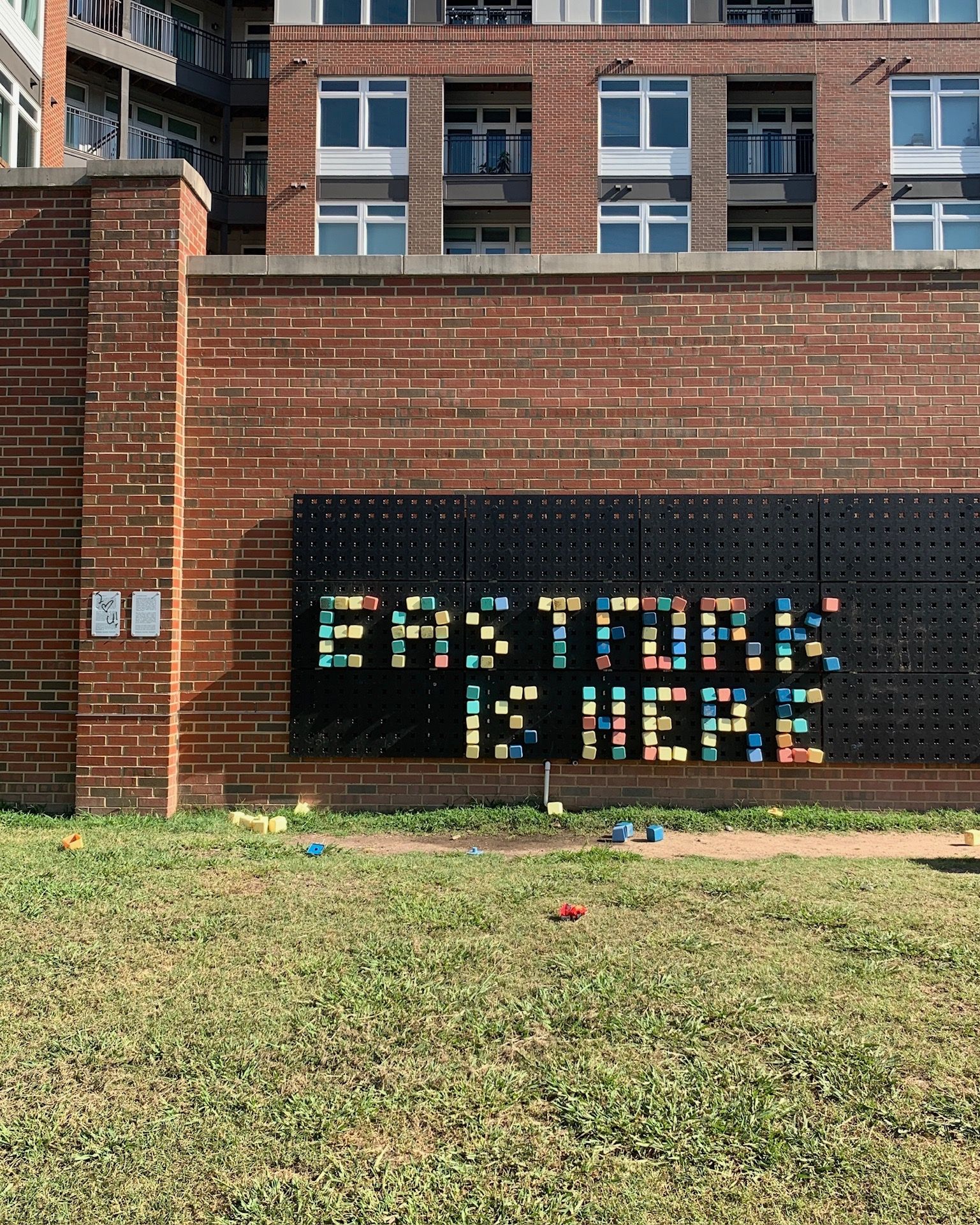 Outside, there is a peg board sign with colorful blocks that reads "East Fork is Here"